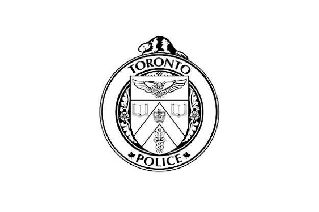 Toronto Police badge with various symbols, including a winged emblem, books, a medical caduceus, and a torch.