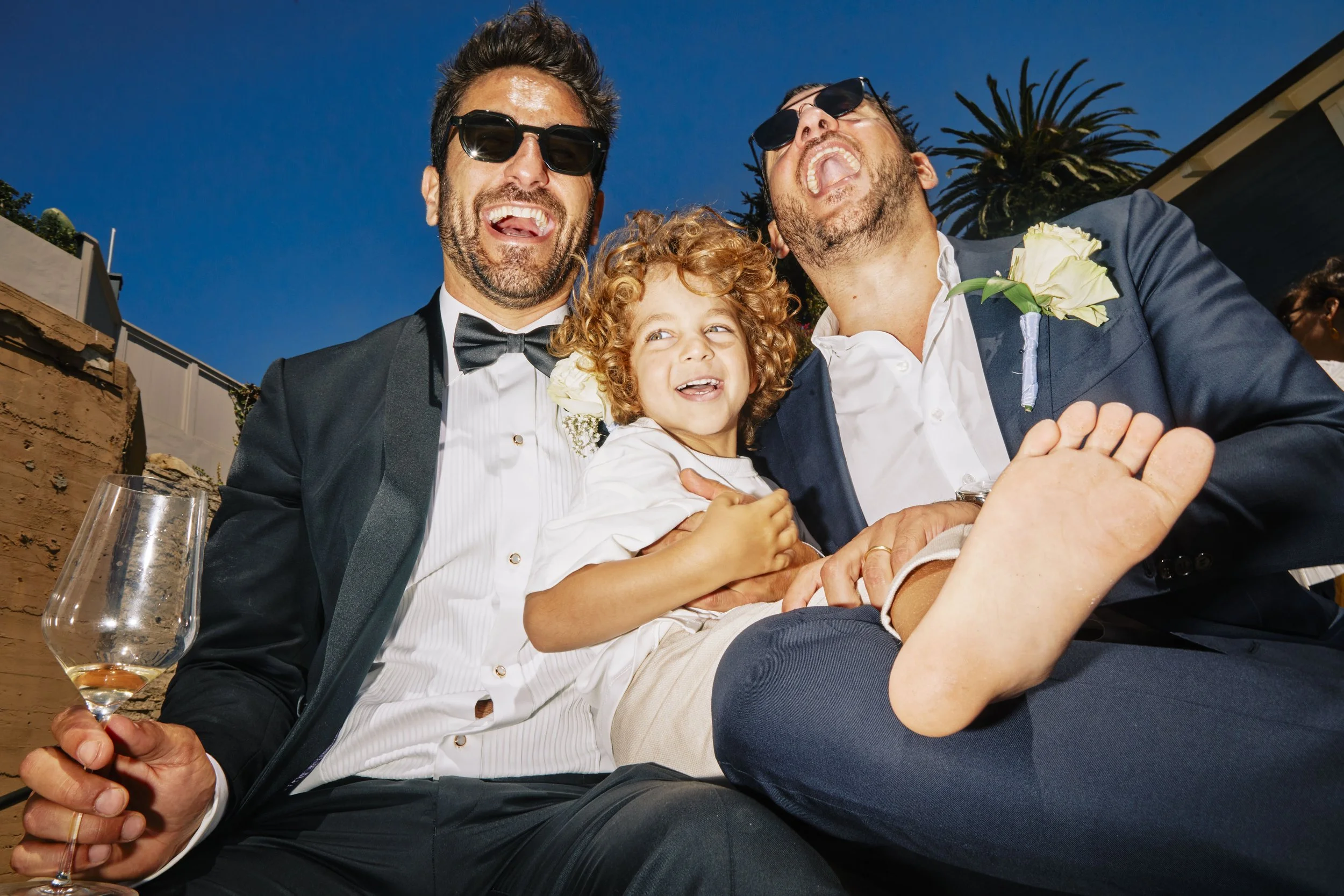 Wedding celebration moment with family and child, photographed in a candid editorial documentary wedding style