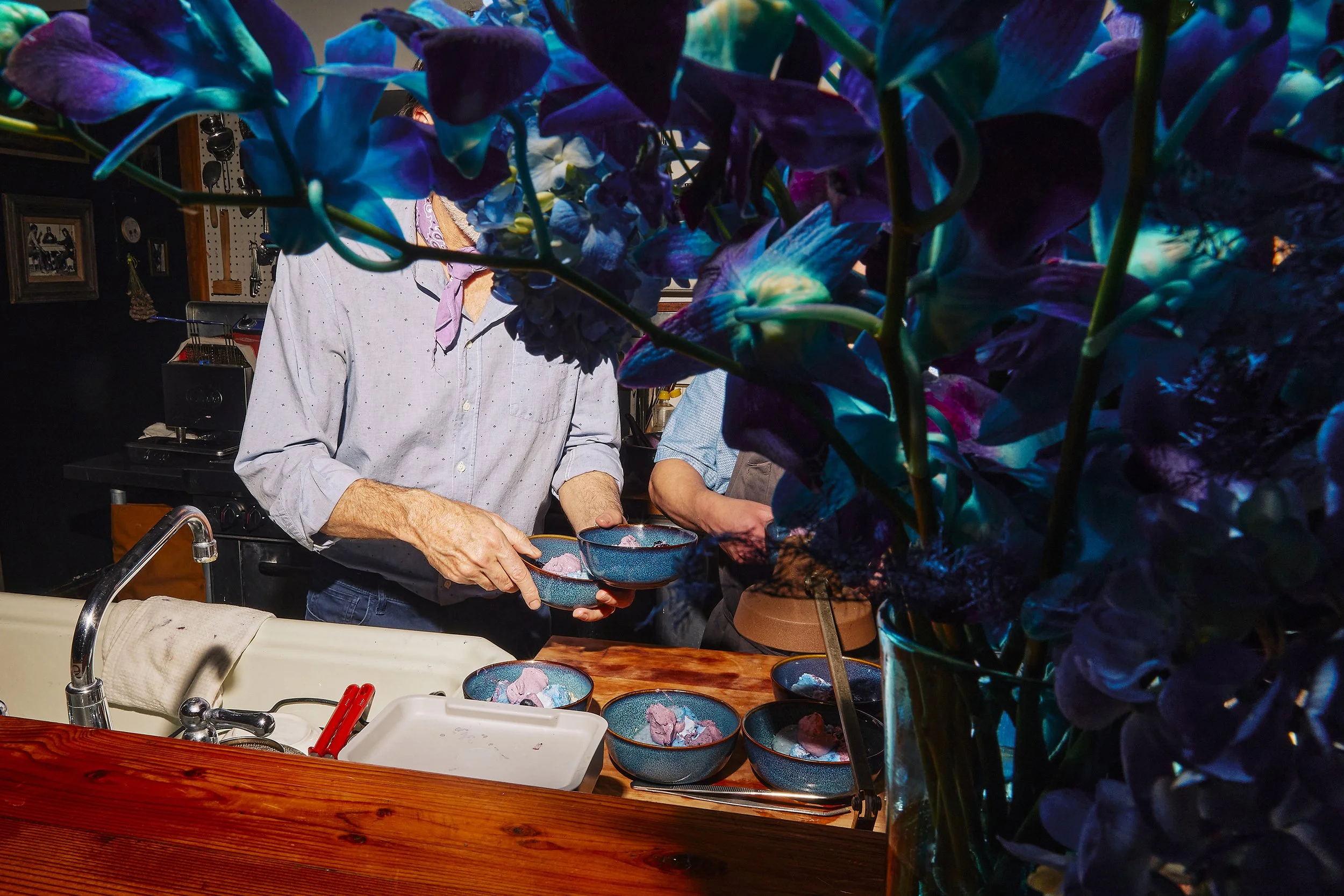 Editorial event photography capturing preparation gestures at a private dinner