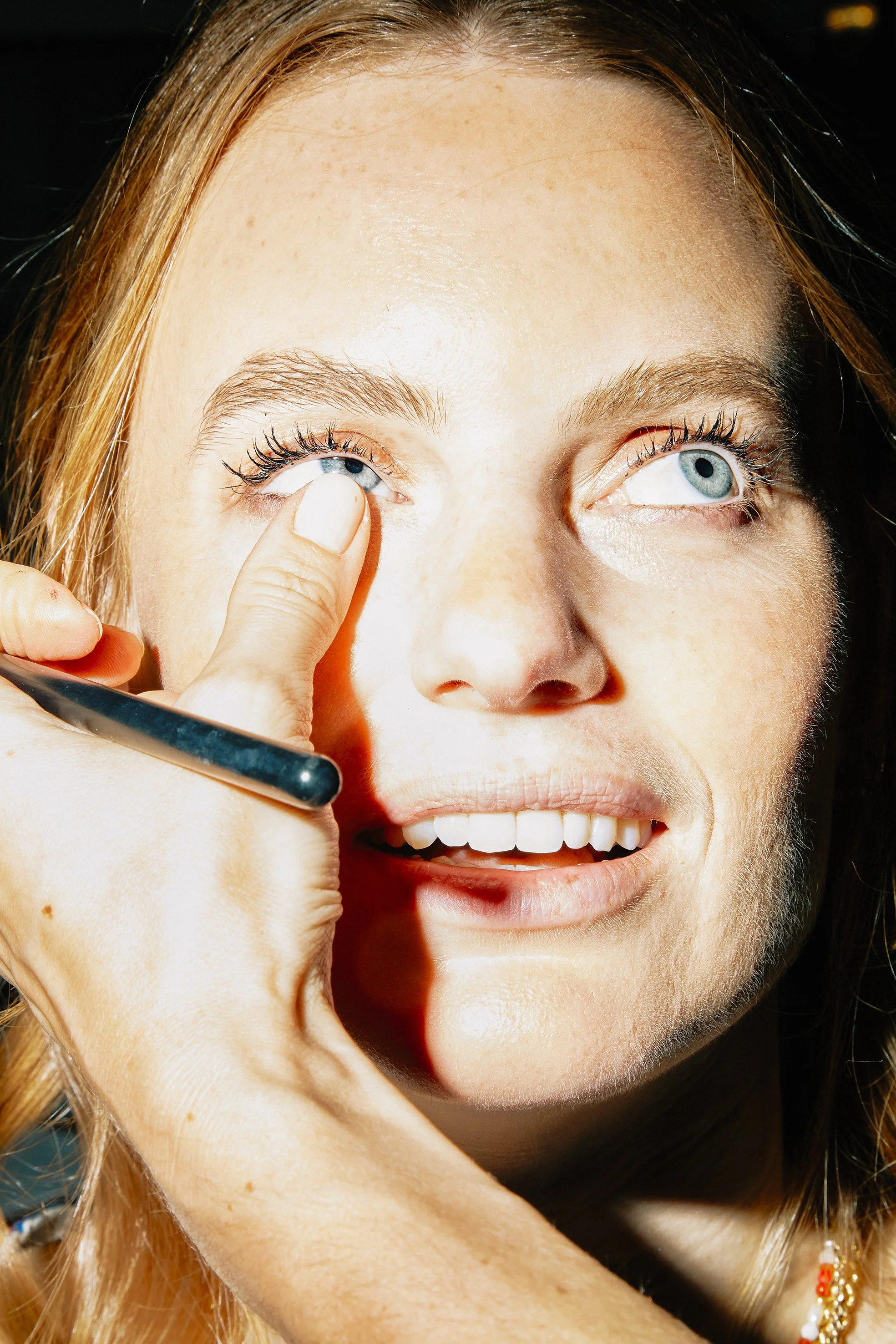 Close-up detail during wedding preparation, capturing gesture and expression in an editorial documentary wedding style