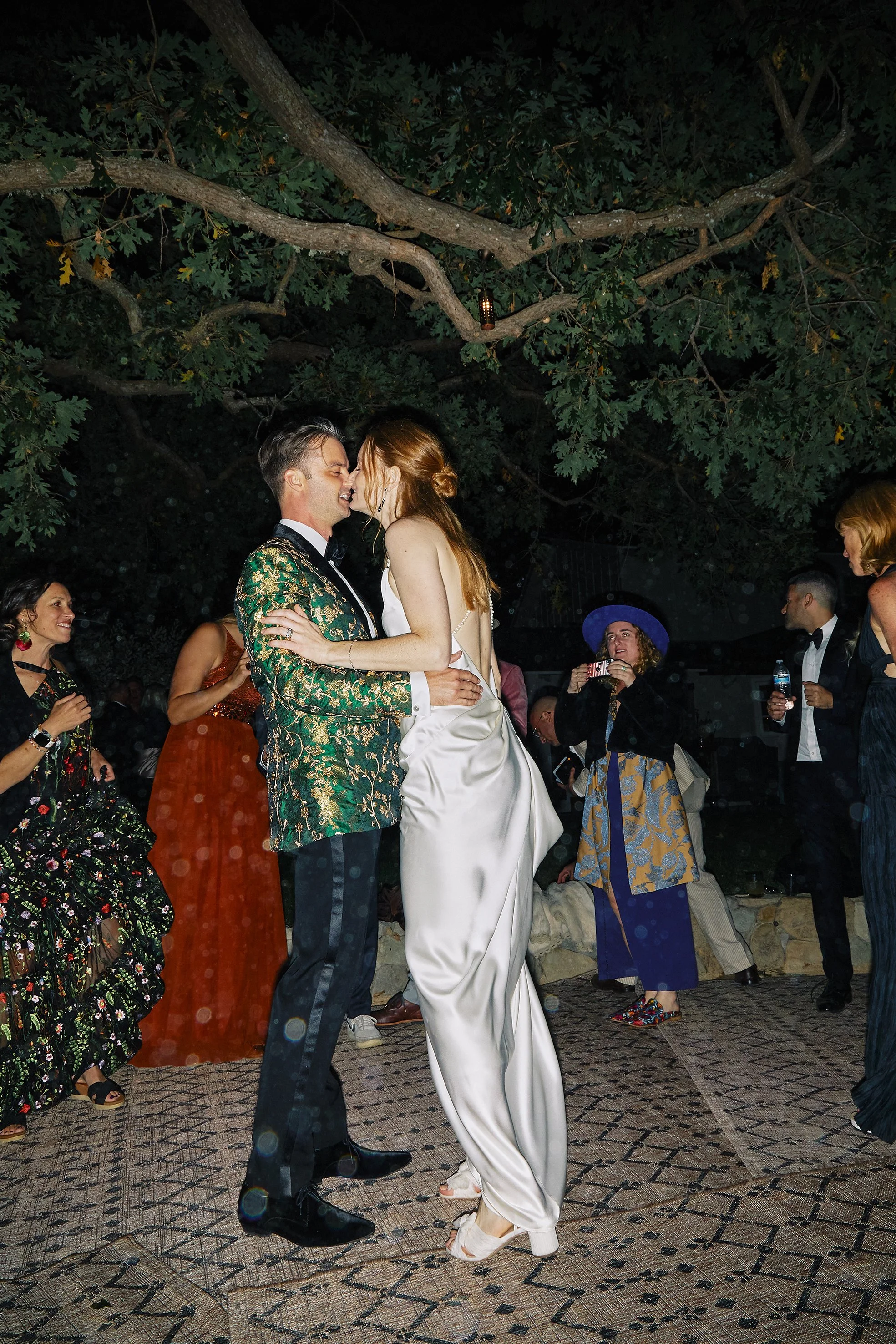 Bride and groom dancing during their wedding reception, photographed in a natural editorial documentary style