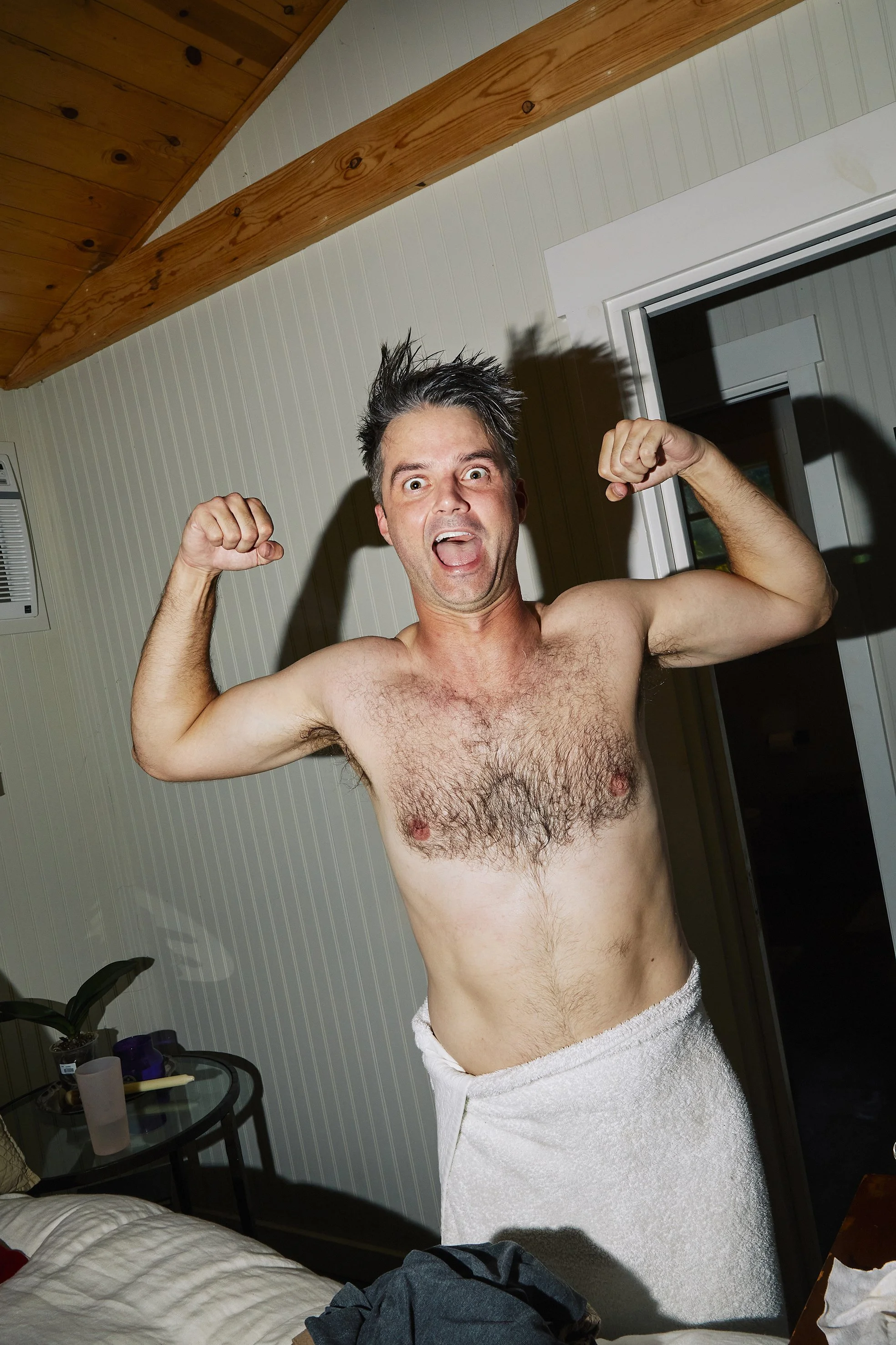 Unposed moment during the groom's wedding preparation showing humor and personality, photographed in an editorial wedding reportage style