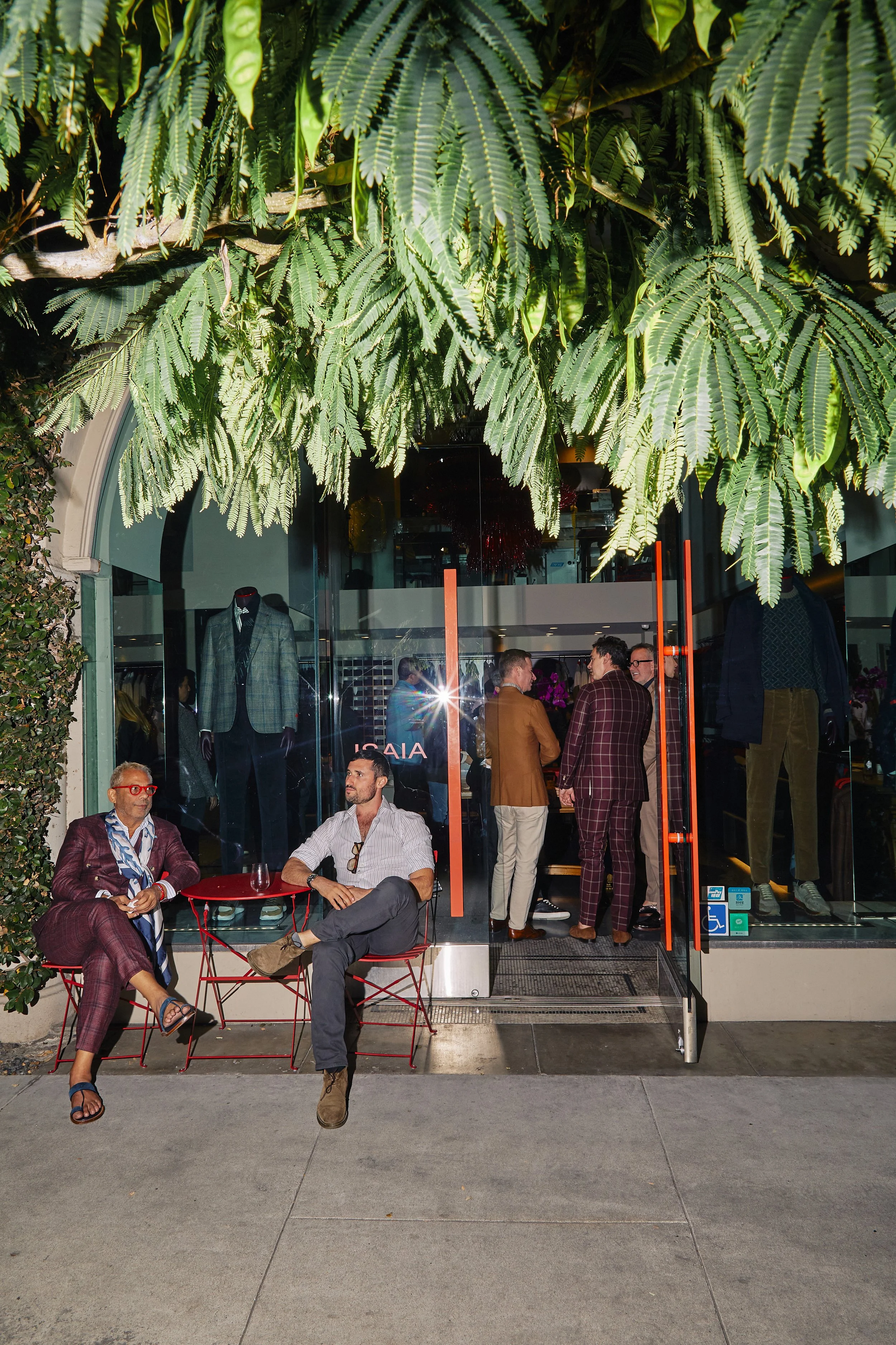Editorial event photography capturing the front of Isaia Napoli's store in Beverly Hills where people are gathered for a collection launch