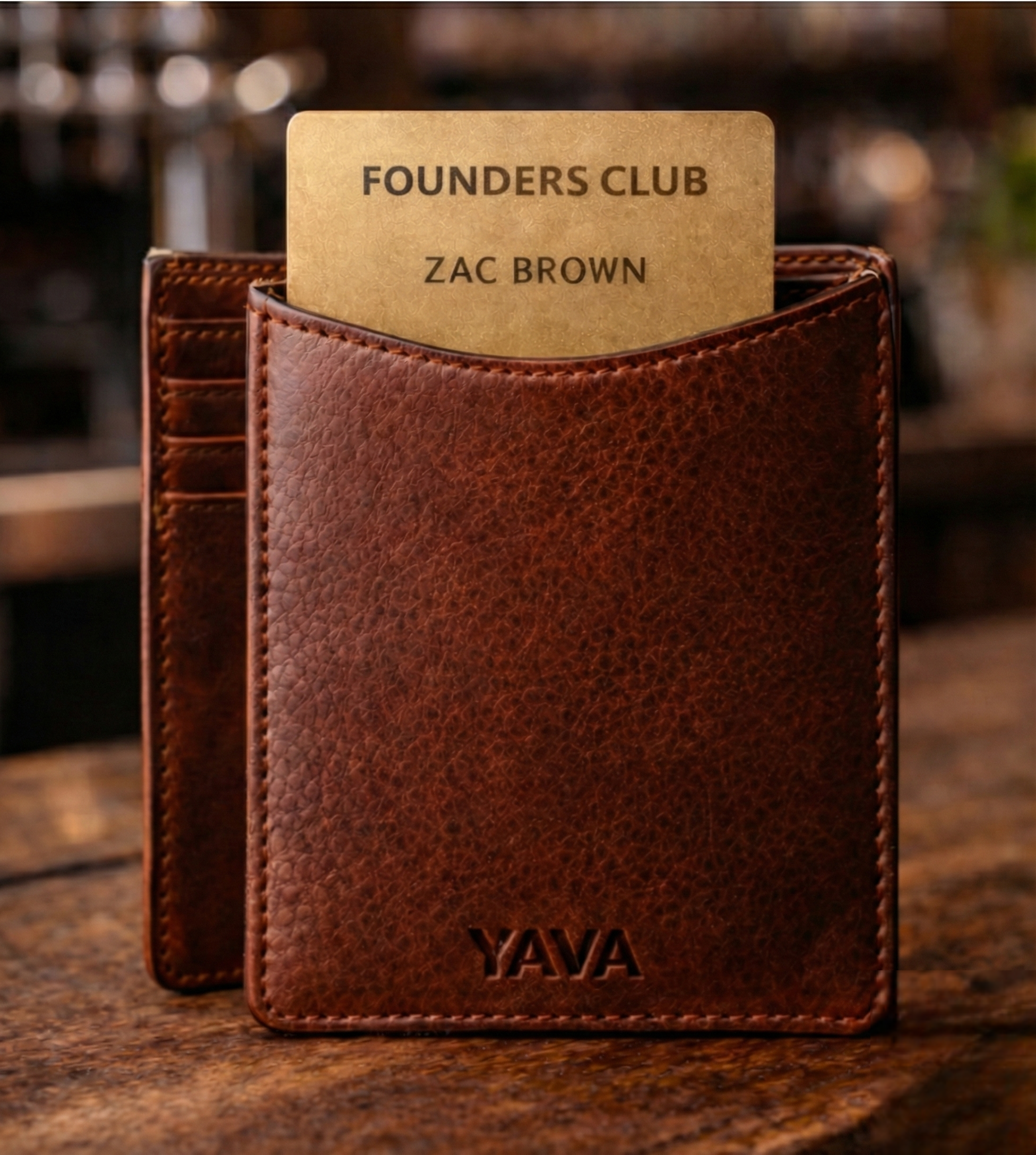 YAVA brown leather wallet with name card sticking out.
