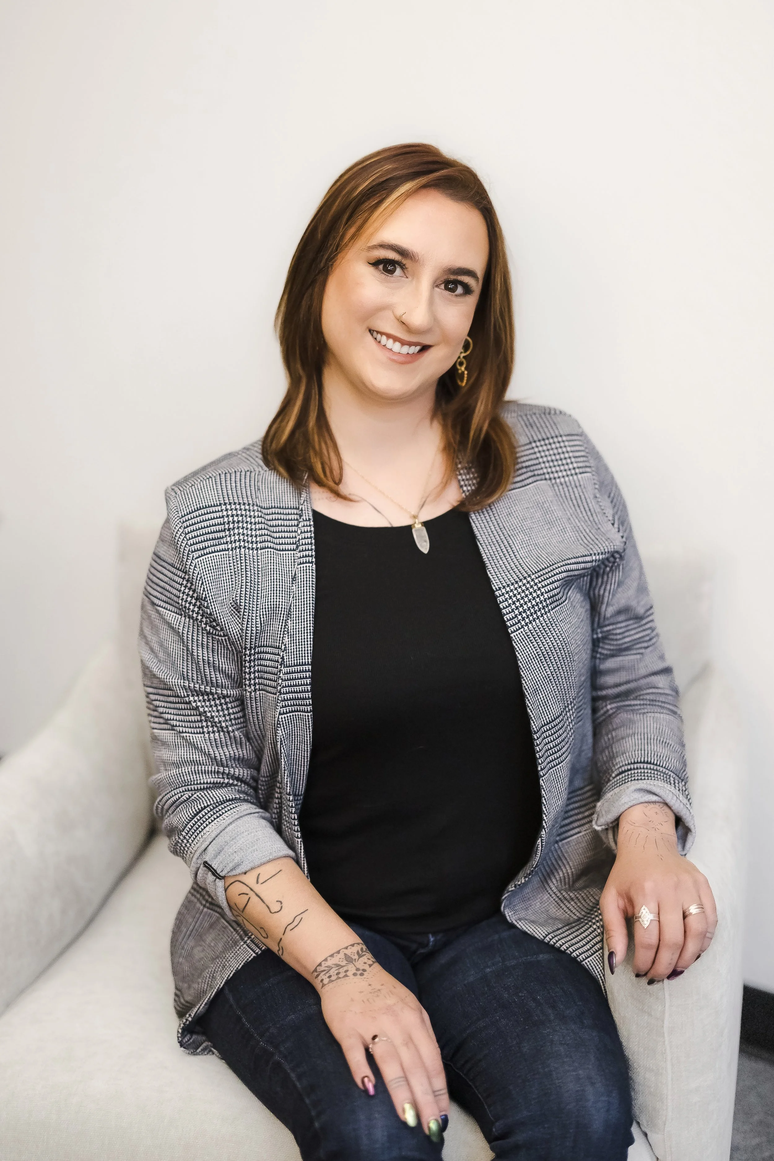 Female Therapist in San Jose smiling in therapy chair