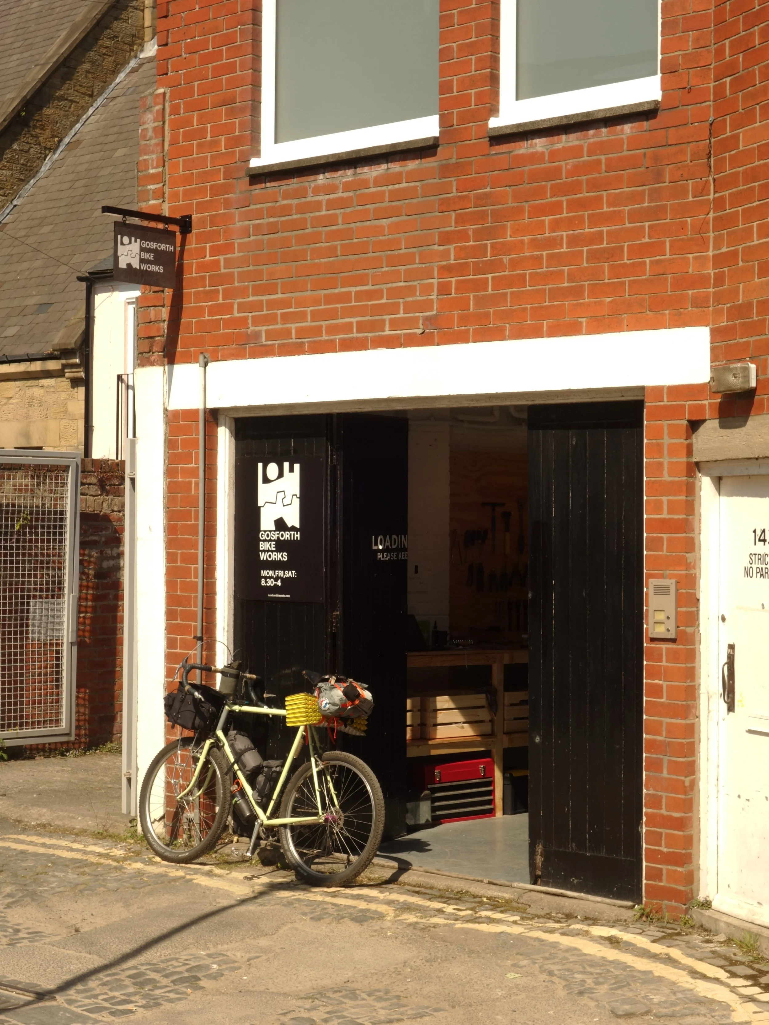 A bicycle parked outside a bike workshop in Gosforth