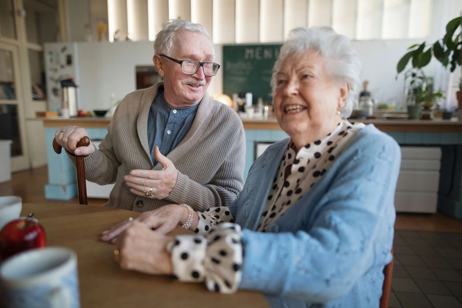 Two older adults smile together after receiving personalized senior care support.
