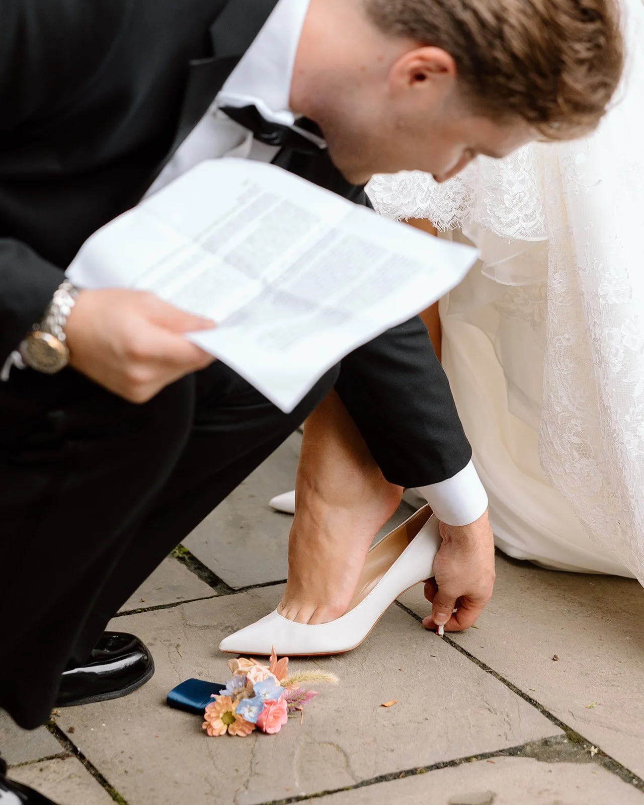 Groom helping bride get ready.jpg