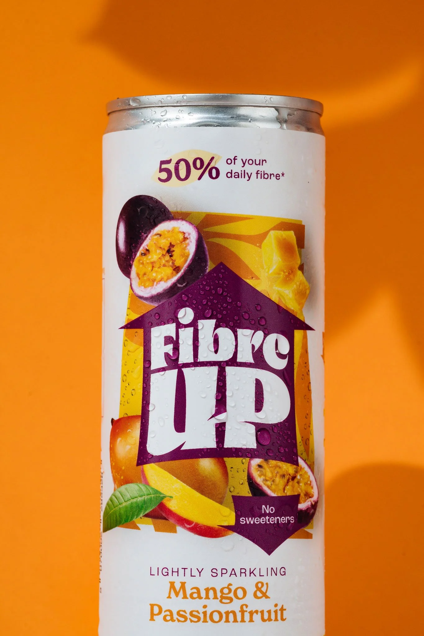 A can of Fibre 1 lightly sparkling mango and passionfruit flavored beverage, displaying vibrant fruit images and nutritional information.