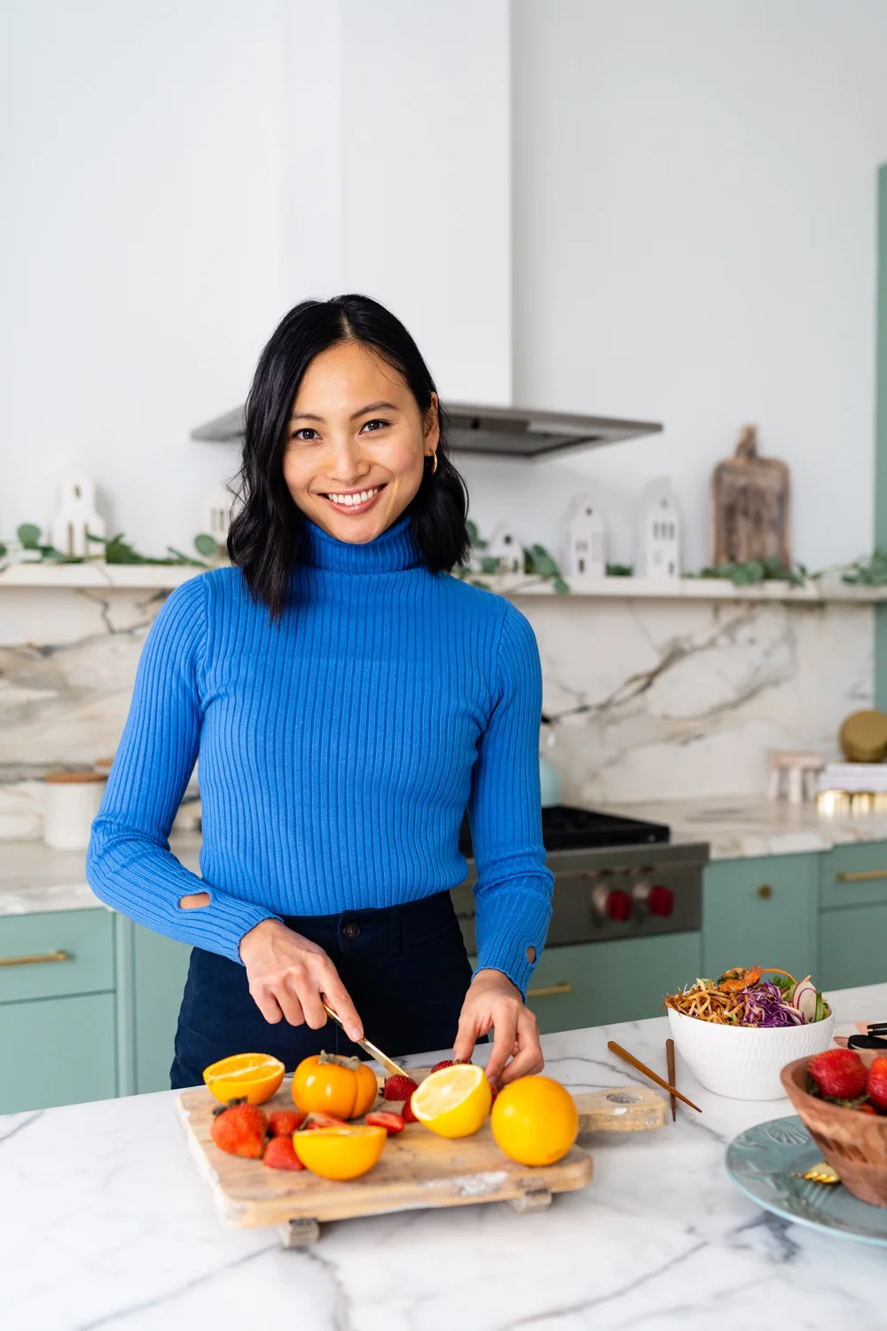 Trista Chan, registered dietitian, preparing fresh fruit in a bright kitchen
