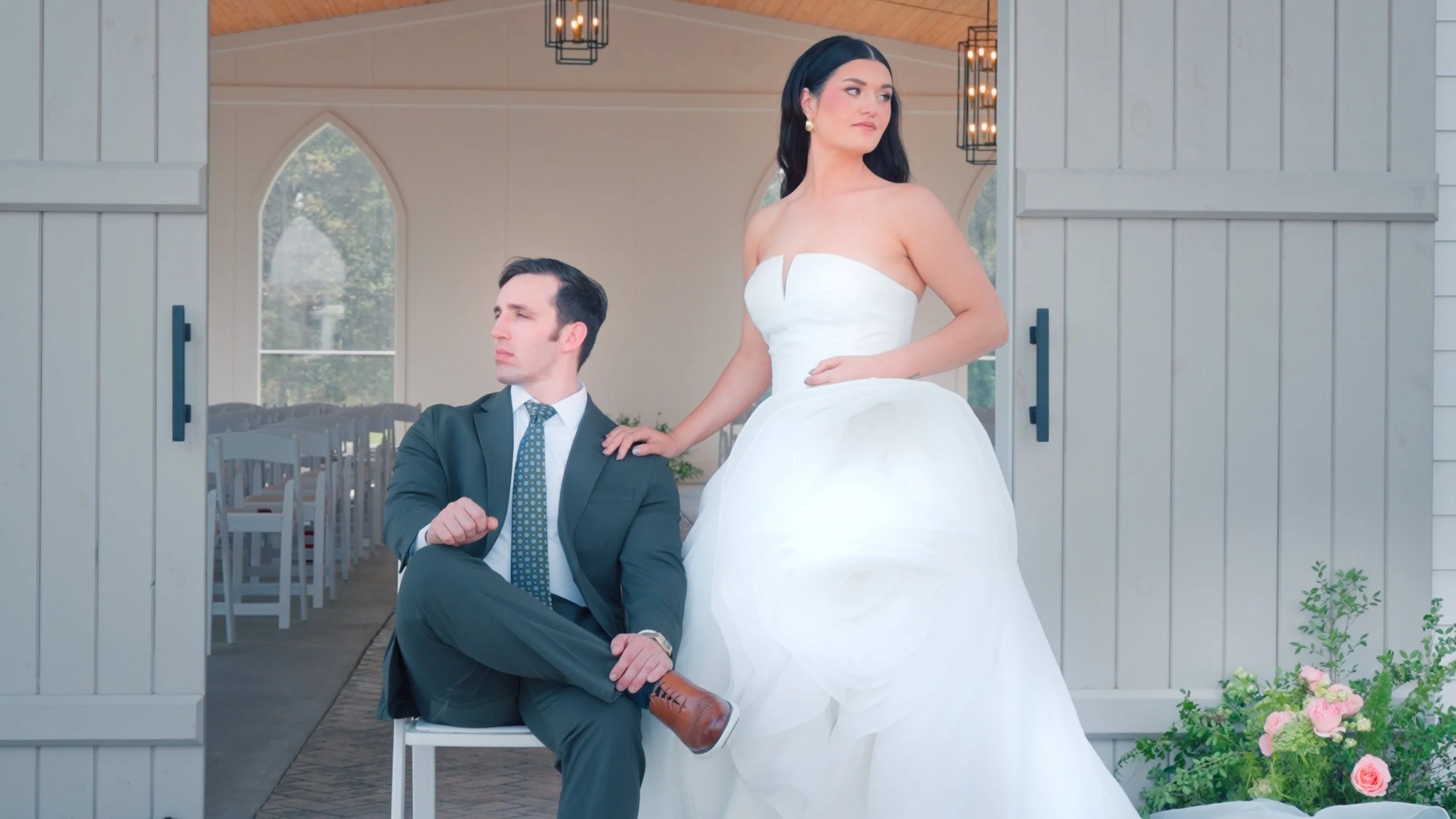 A bride with blonde hair in a white dress holding a bouquet of flowers, surrounded by several bridesmaids in matching mauve dresses, all holding lace umbrellas in an outdoor garden setting.
