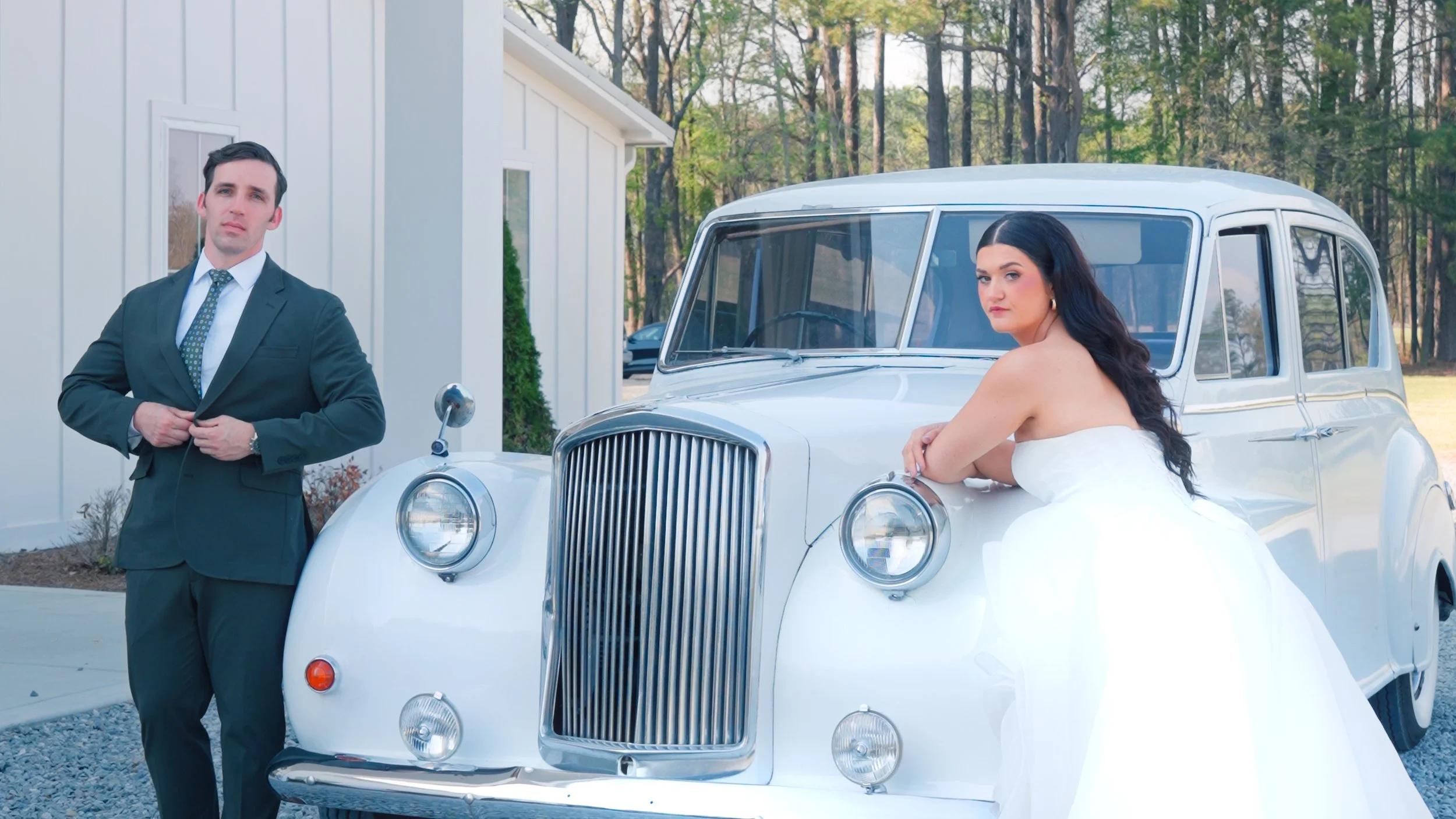 A happy bride and groom holding hands and walking through a sunflower field on a sunny day.