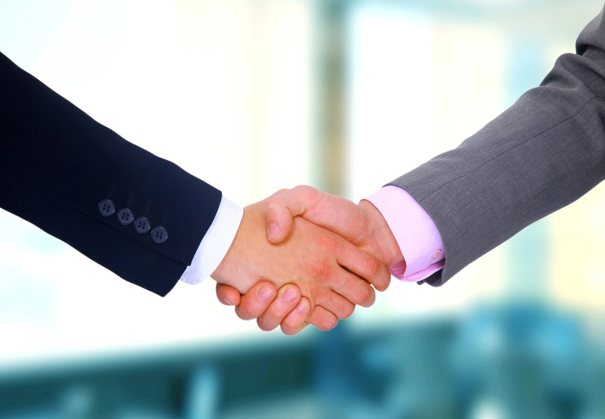 Business partners shaking hands to represent trust and long-term collaboration in the U.S. market.