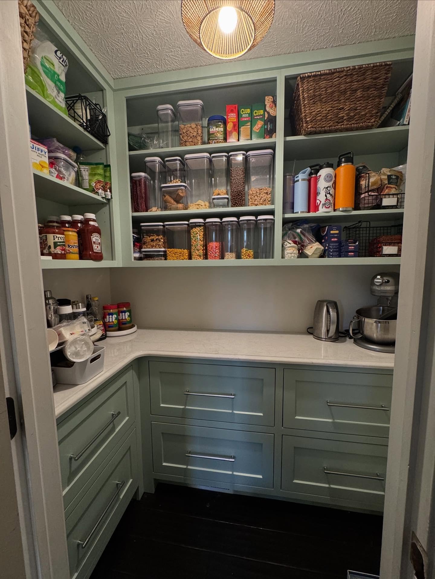 This pantry went from typical white wire shelving to beautiful custom cabinets that maximized the storage.