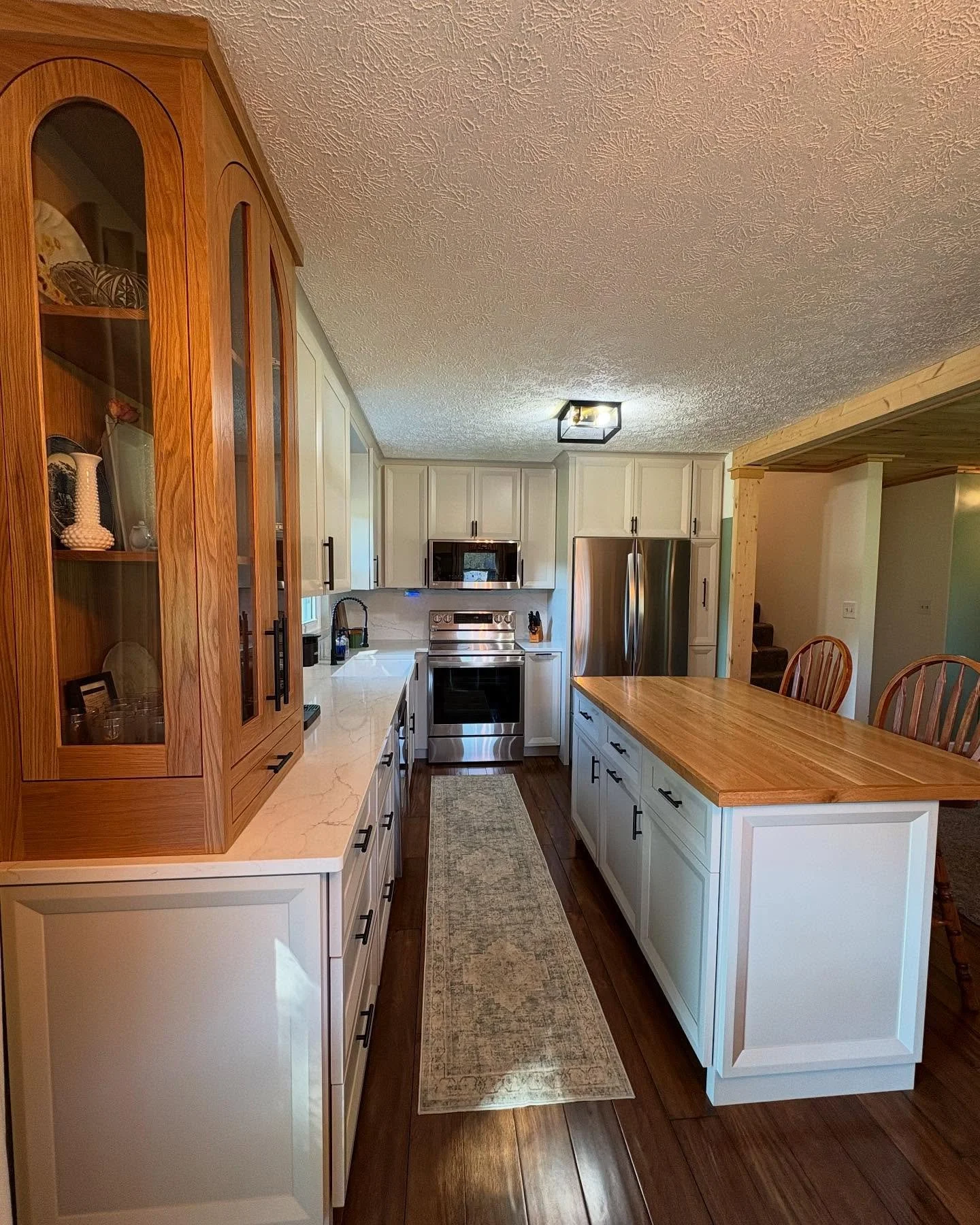 Another kitchen in the books! There are lots of custom touches to this kitchen from the adjustable pantry pull outs for maximized storage, utensil pull out right by the oven for quick access, and the White Oak glass cabinet for displaying ornamental 