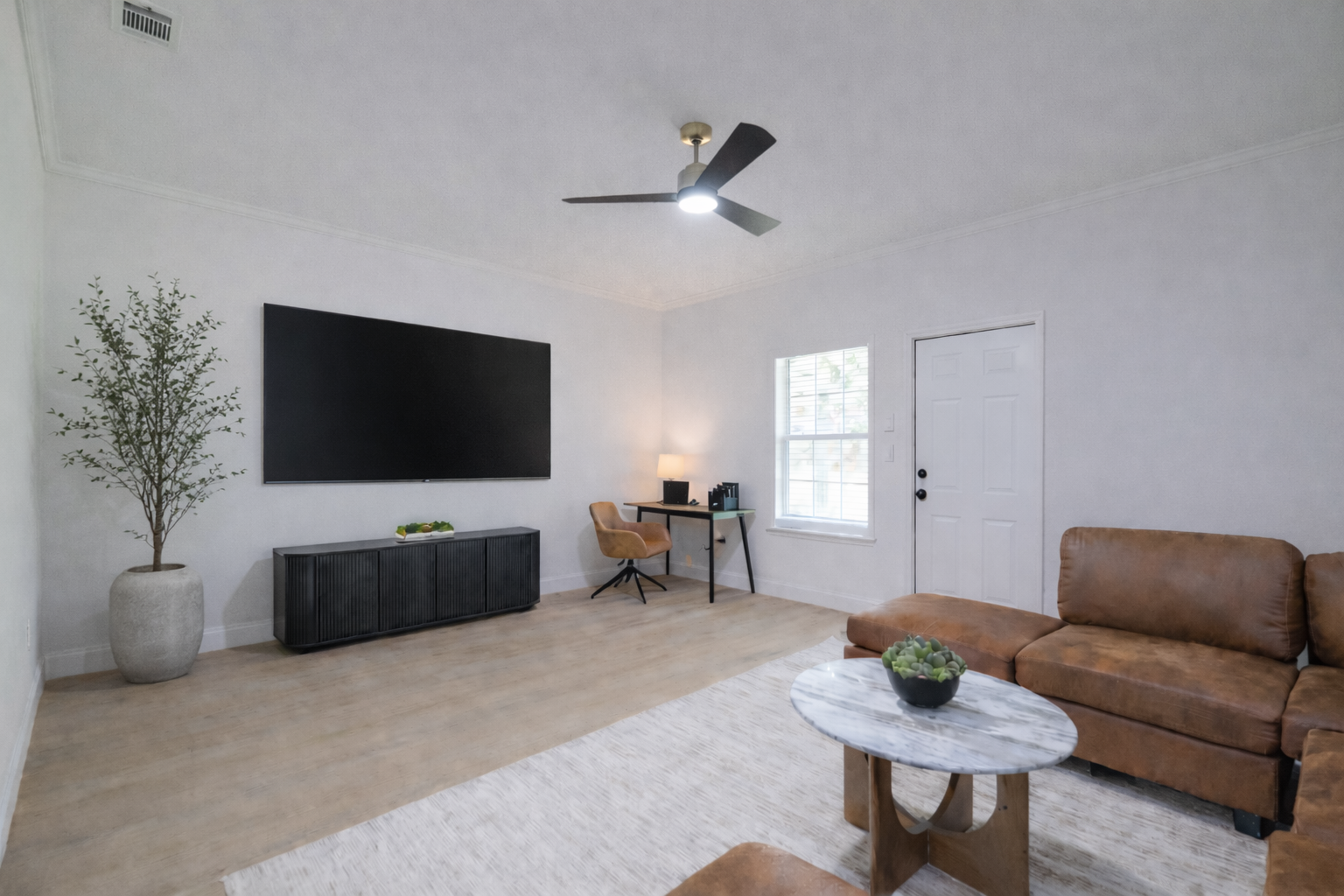 Modern living room with office setup.png