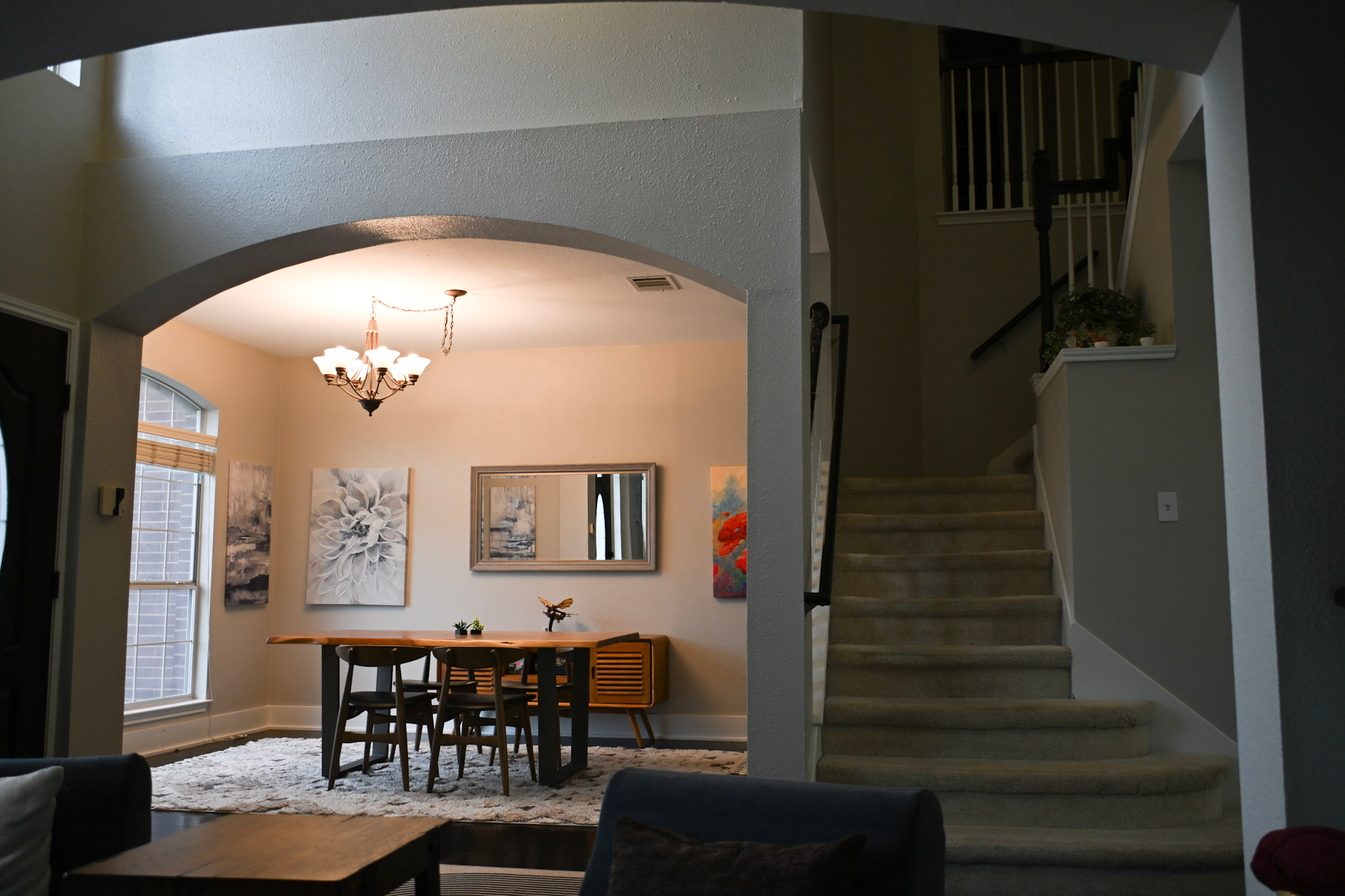 View of the modern dining room and stairs at Fireside Sober Living in Austin, Tx.
