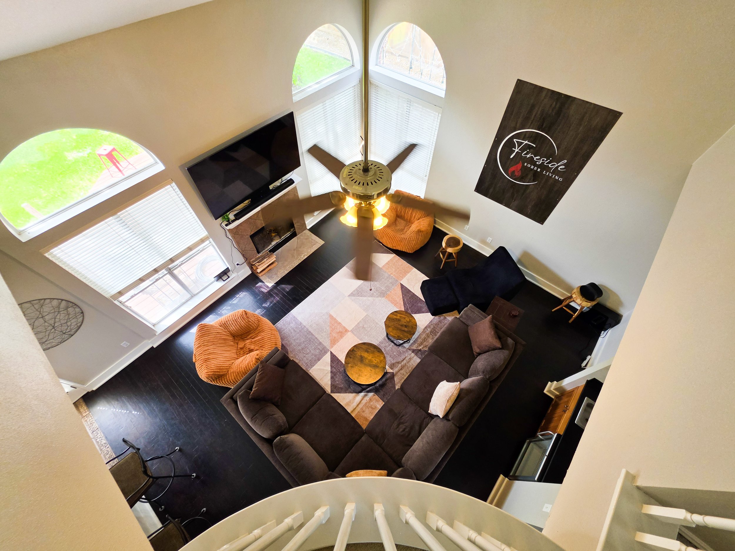 Overhead view of a spacious living room at the Fireside house. Fireside Sober Living offers alternative, non-AA, non-traditional, AA, and traditional program modalities.