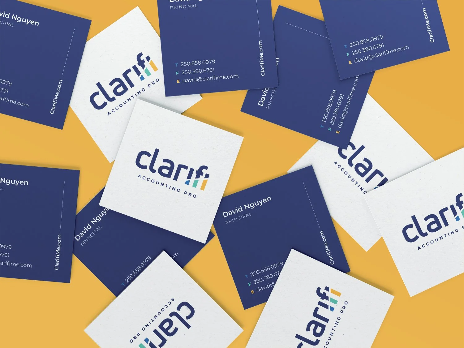 Multiple business cards for Clarifi Accounting Pro scattered on a yellow surface, with blue and white designs and contact information.
