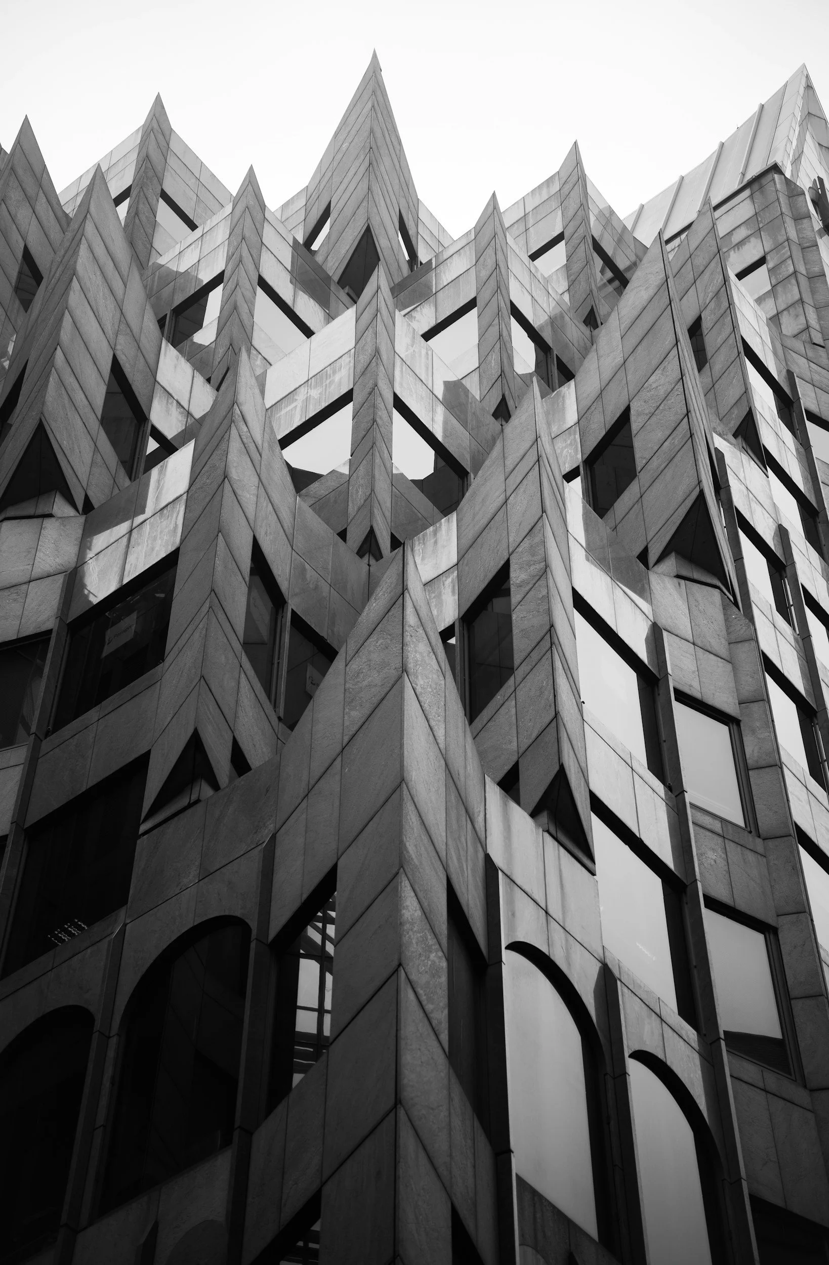 Black and white photo of a modern building with geometric patterns and sharp angles.