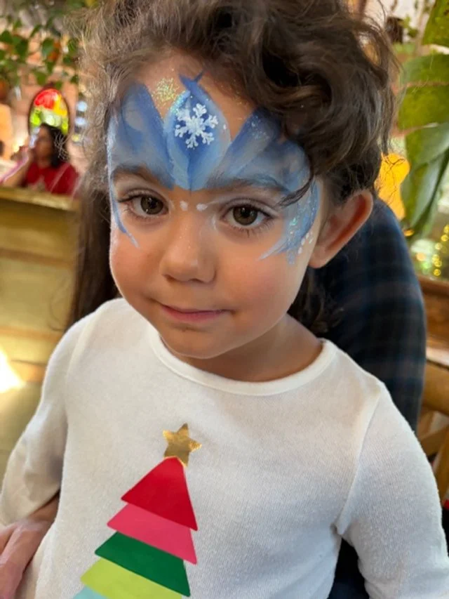 Child with painted Elsa crown