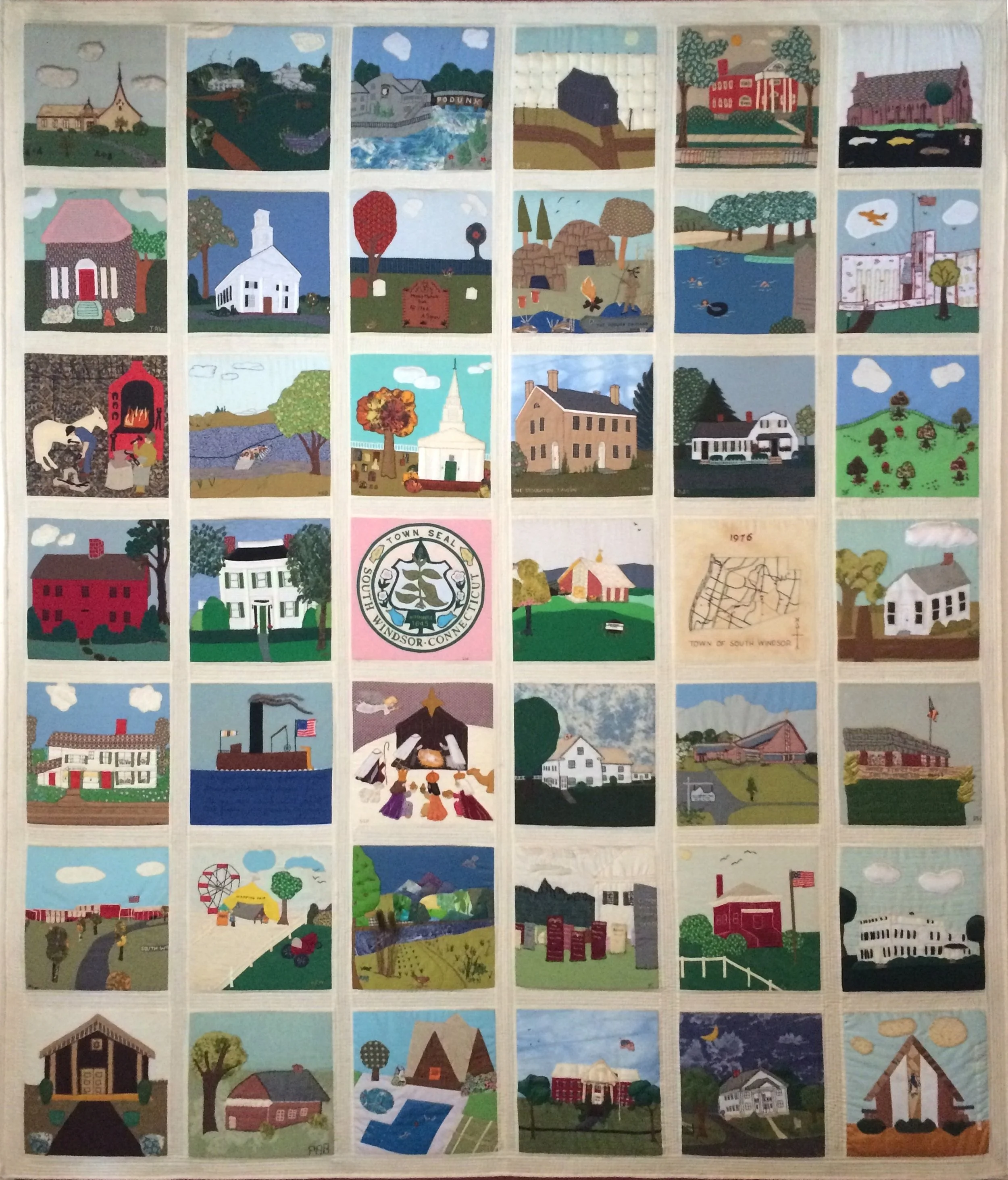 A quilt with multiple square panels depicting scenes from Windsor, Connecticut, including churches, houses, trees, lakes, a Ferris wheel, and local landmarks.