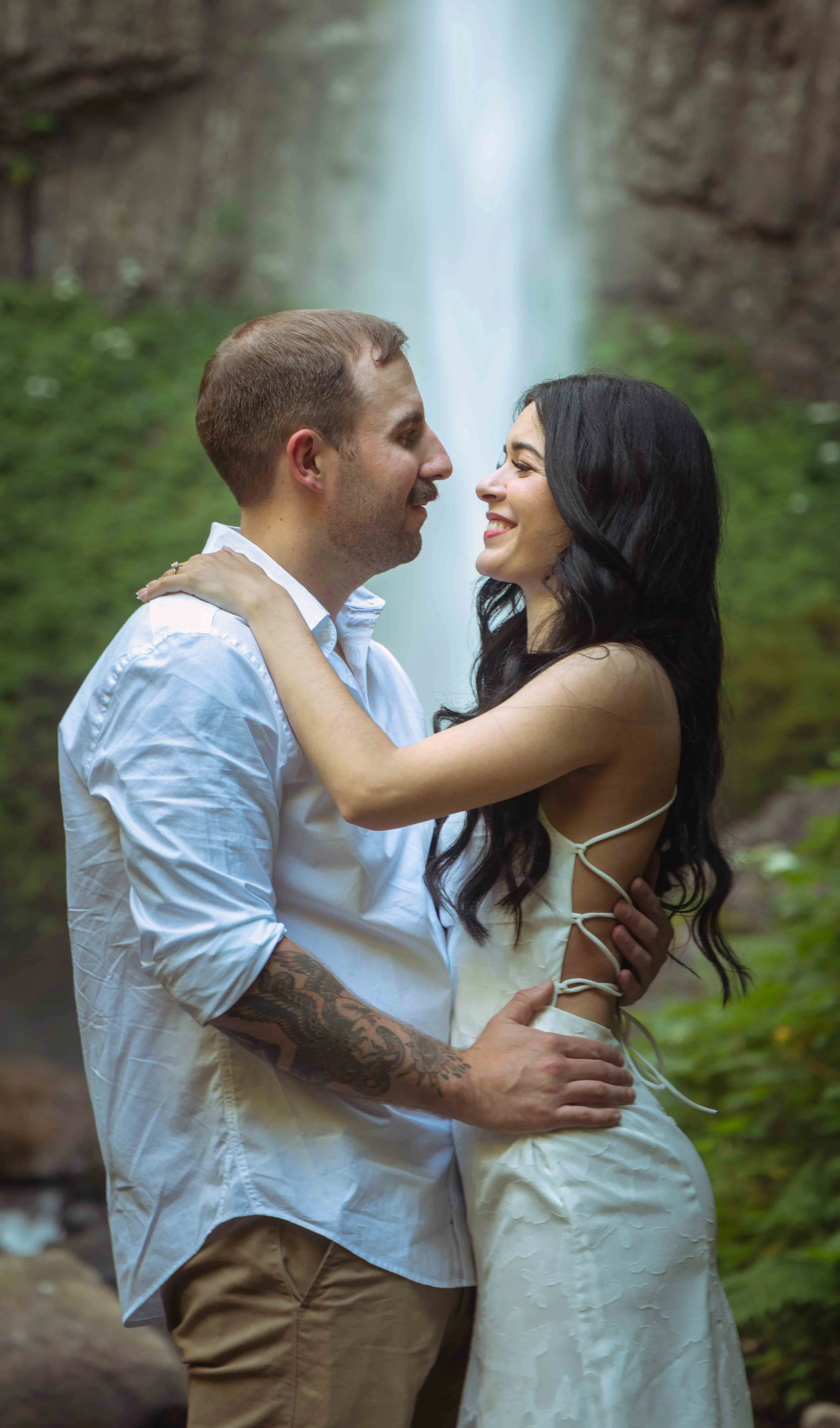 in front of waterfall embrace smile film style copy.jpeg