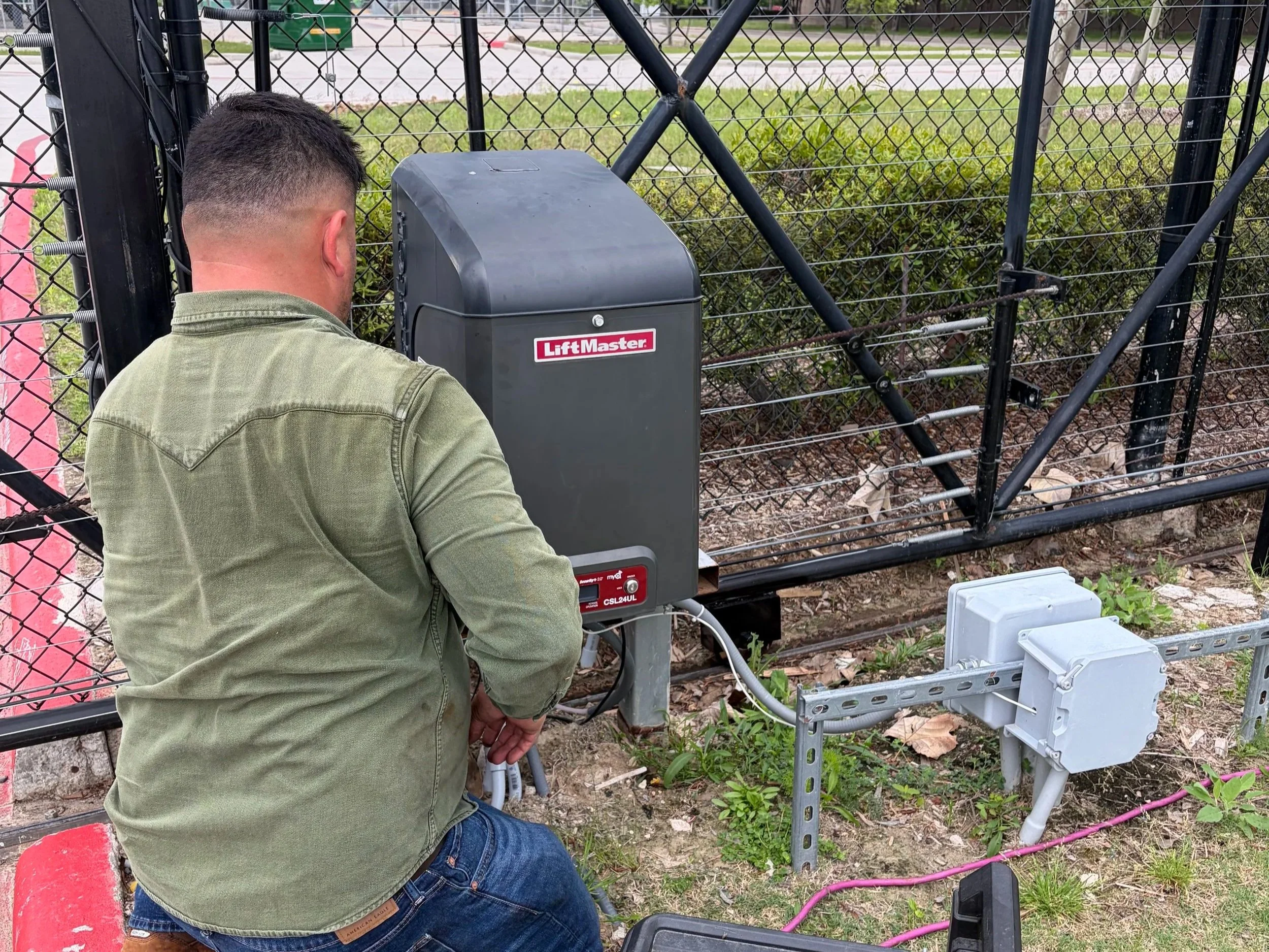 Technician working on a gate repair in Houston.