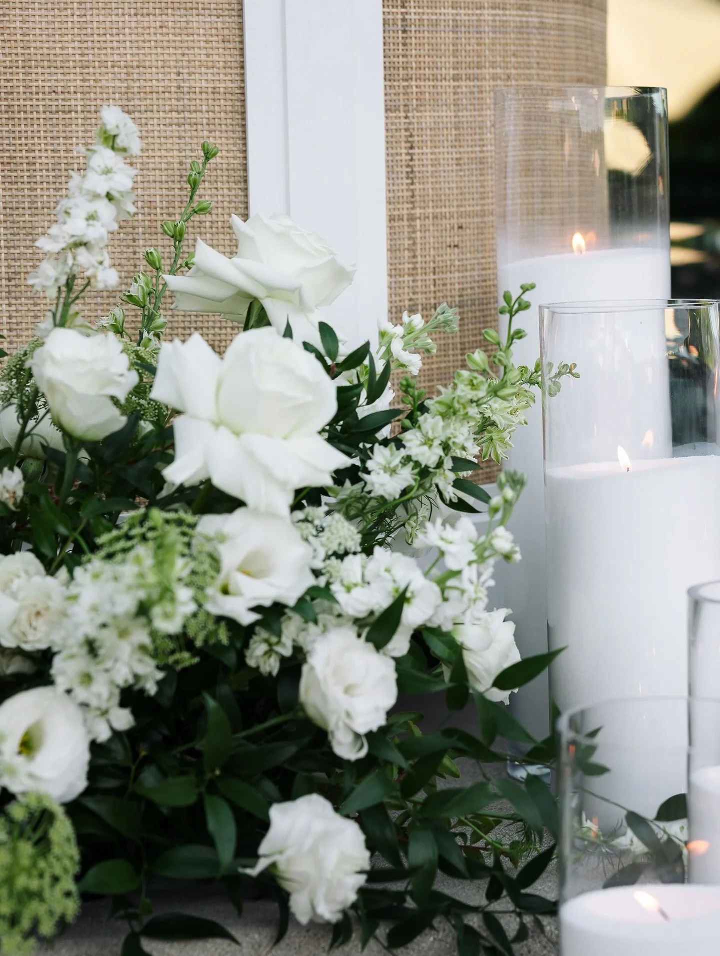 Reception details for Aly &amp; Matt
Featuring a lush green garland with white roses for their long guest table, ground arrangements for their welcome sign &amp; bar, greenery to frame the pool, and romantic candle light 

Planning: @vandgcharcuterie