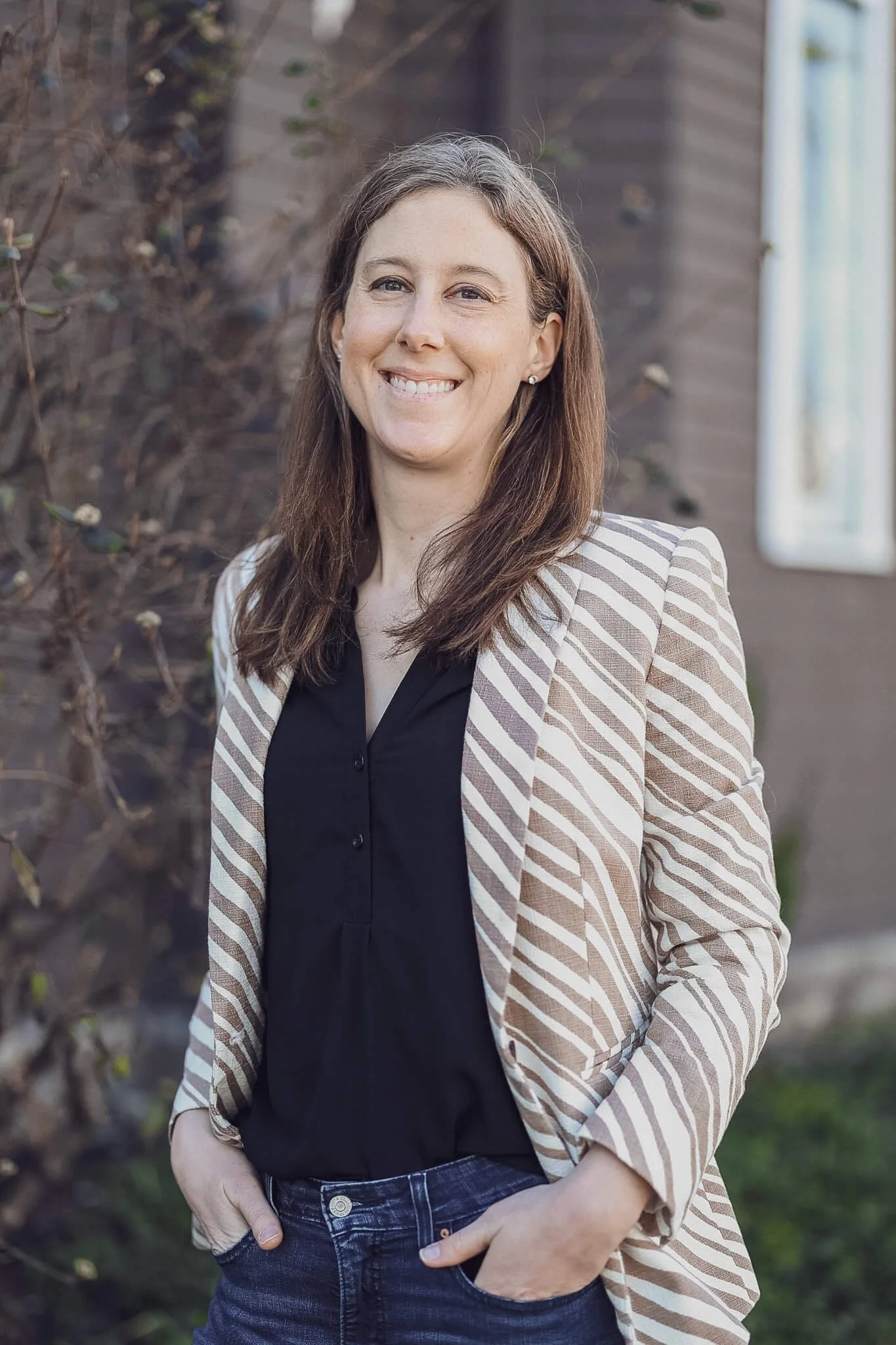 Smiling female nurse practitioner who oversees all caregivers.