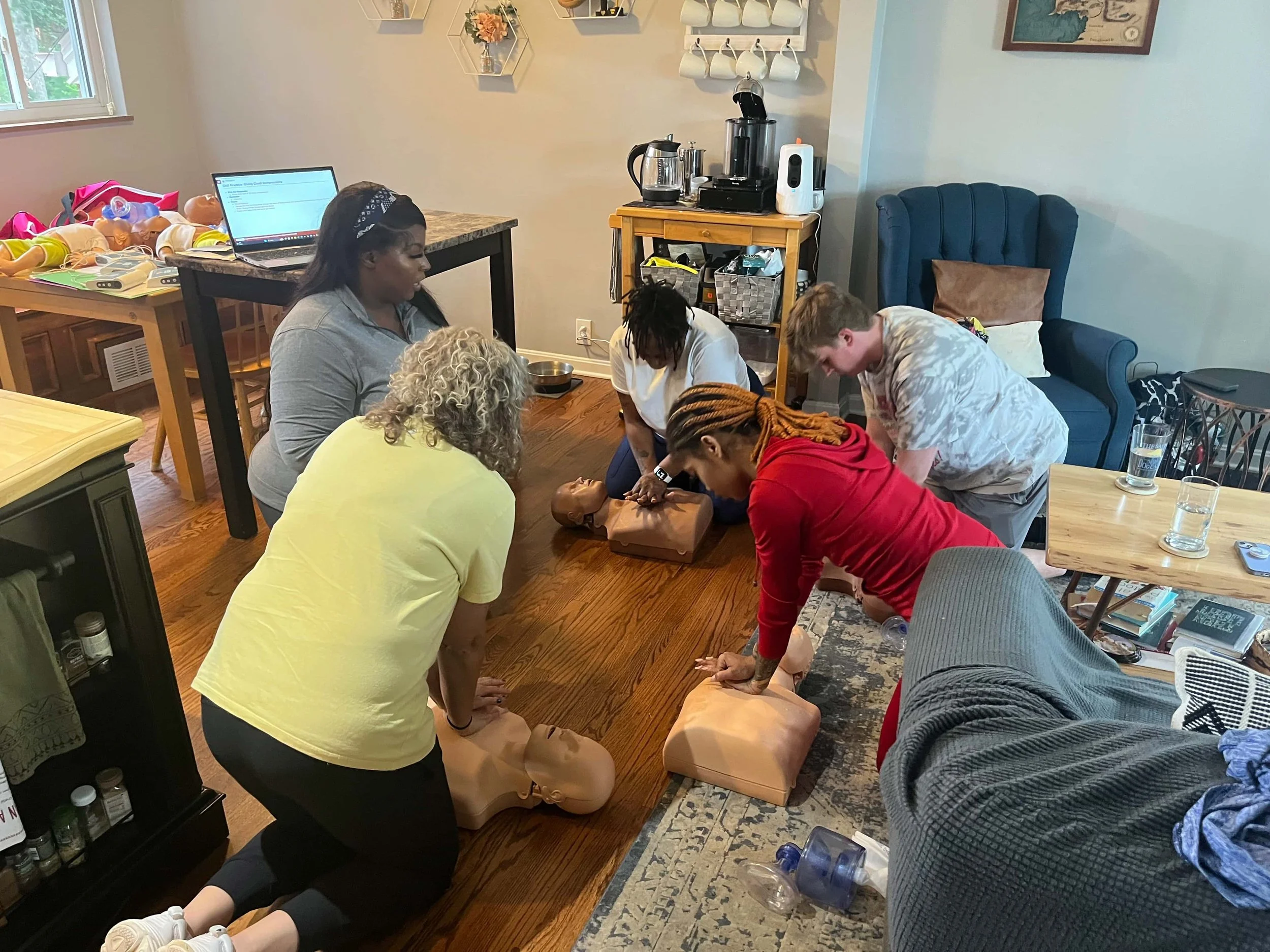 4 women and one man caregivers doing CPR training for second mile home care