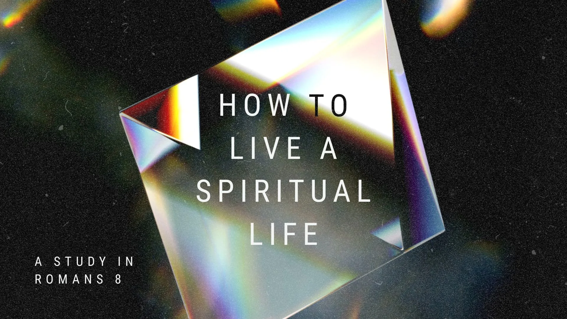 Text overlay on a holographic, iridescent cube: "How to Live a Spiritual Life." Smaller text reads "A Study in Romans 8" against a dark background.
