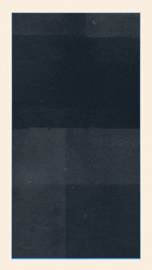 A dark, vintage slide projector with a rectangular shape and a lens at the front, placed on a flat surface.