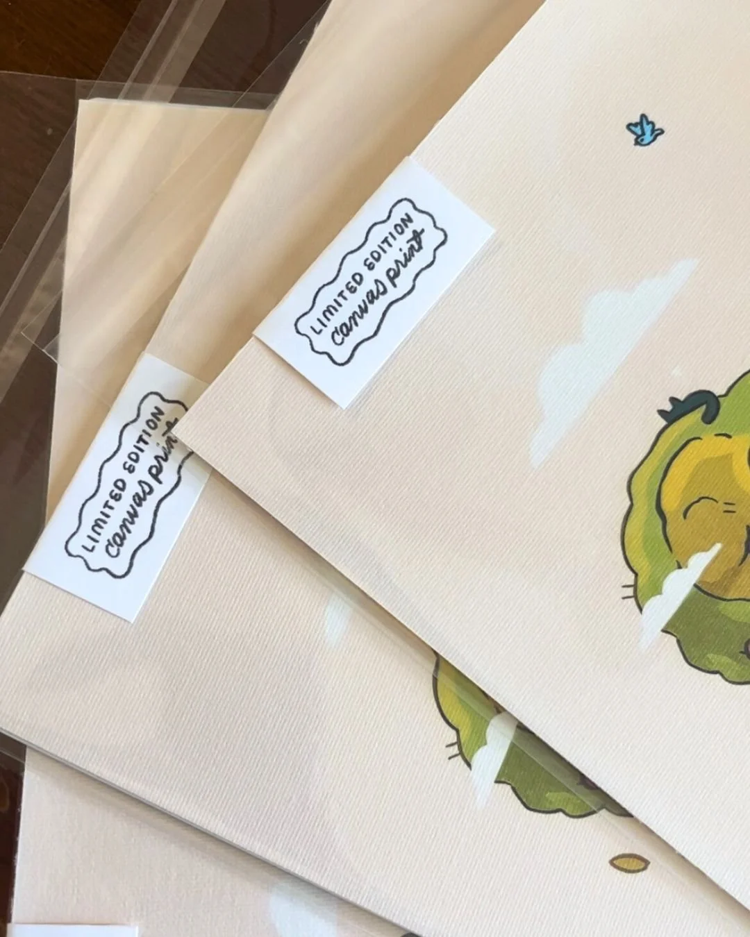 Two framed prints with a cartoon lettuce character and clouds, labeled with handwritten signs that read 'Limited Edition Conward Print'.