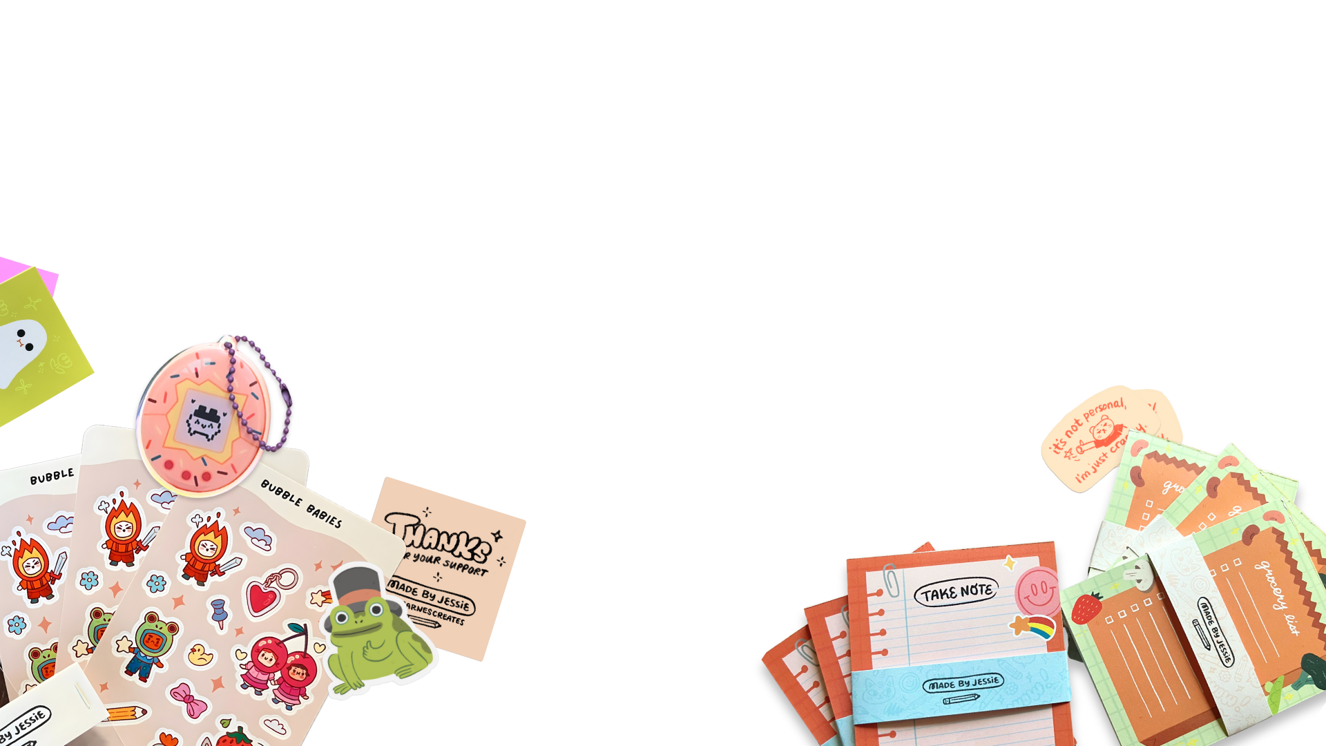 Decorative stationery and accessories on a table, including stickers, notepads, and a keychain with a pink donut design.