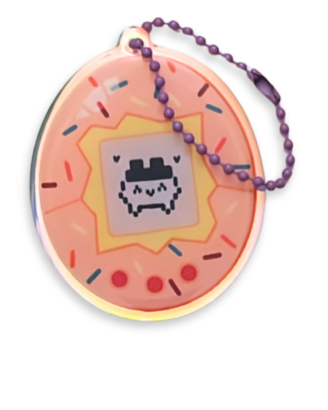 Pink circular keychain with pixel art skull and rainbow sprinkles design, purple bead chain, and black background.
