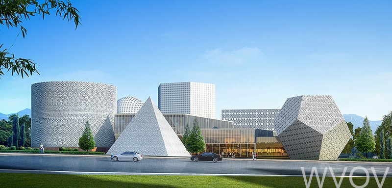 Modern architectural building with Geometric shapes including a cone, cube, pyramid, and irregular polyhedron, set against a blue sky and mountainous background with trees and cars in the foreground.