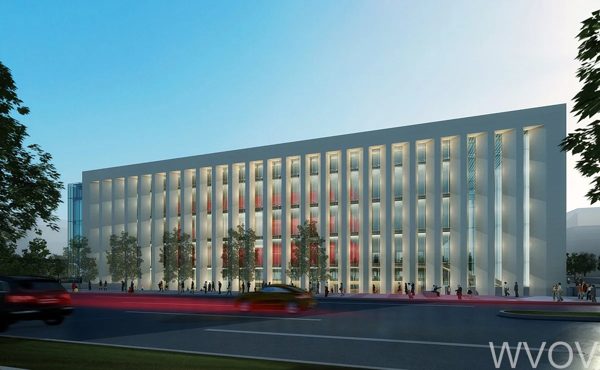 Modern multi-story building with vertical white beams, glass windows, and illuminated interior, surrounded by trees and a busy road with cars and pedestrians.