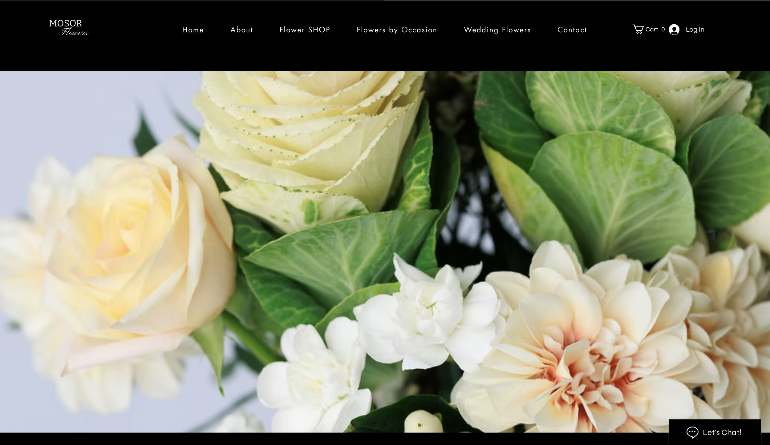 Close-up of a floral arrangement with white roses, green leaves, and peach-colored flowers.
