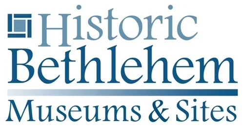 Logo of Historic Bethlehem Museums & Sites with blue wave design and text in different fonts.