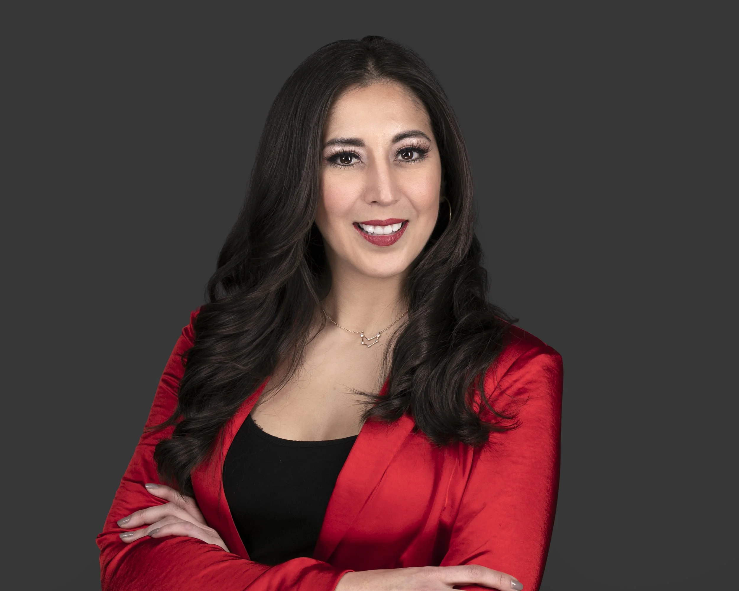 Sara Viteri wearing a red blazer