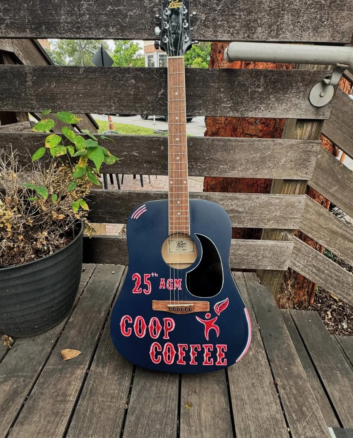 Acrylic and spray paint on a wooden guitar