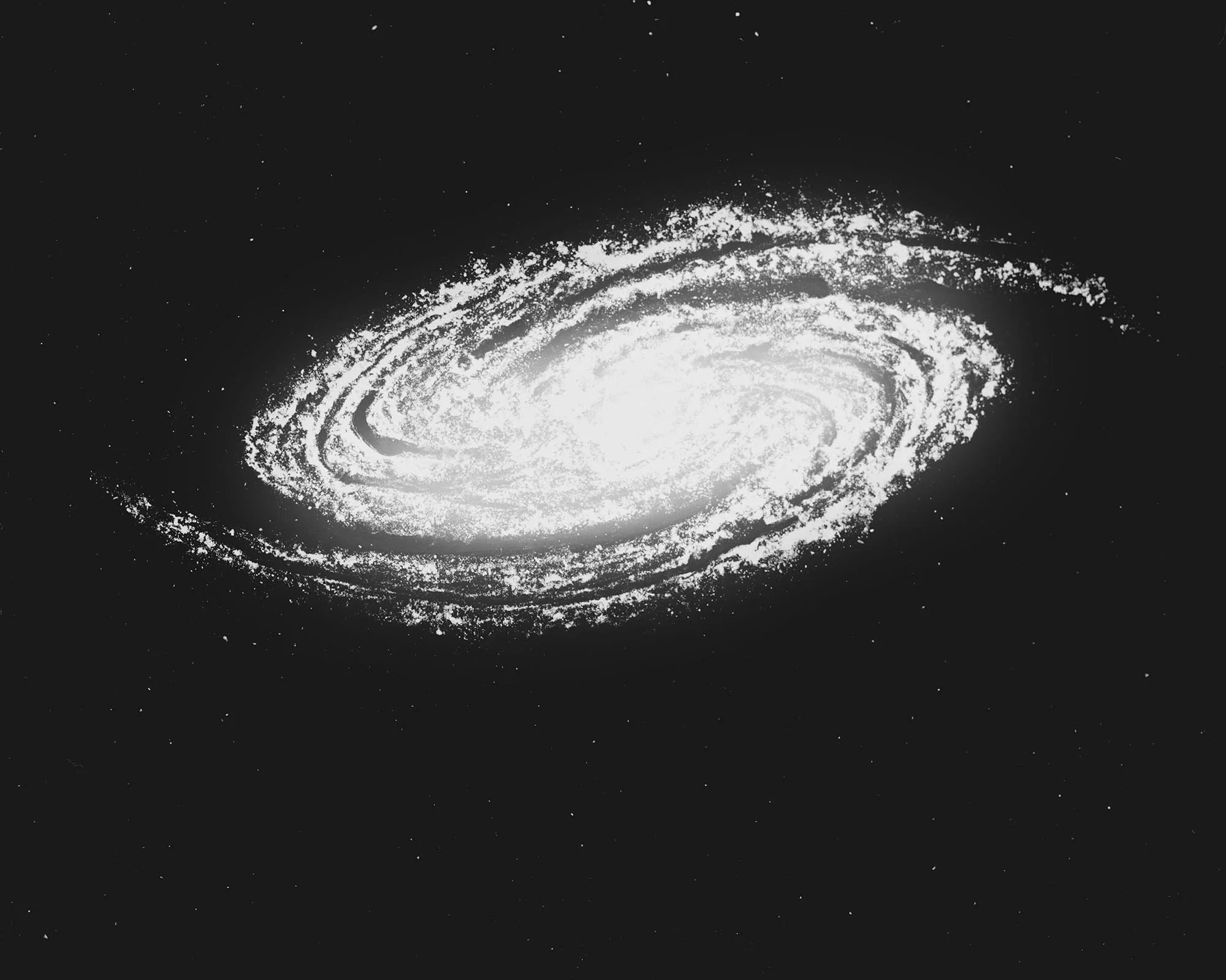 Black and white image of a galaxy with bright central core and spiral arms, surrounded by stars.