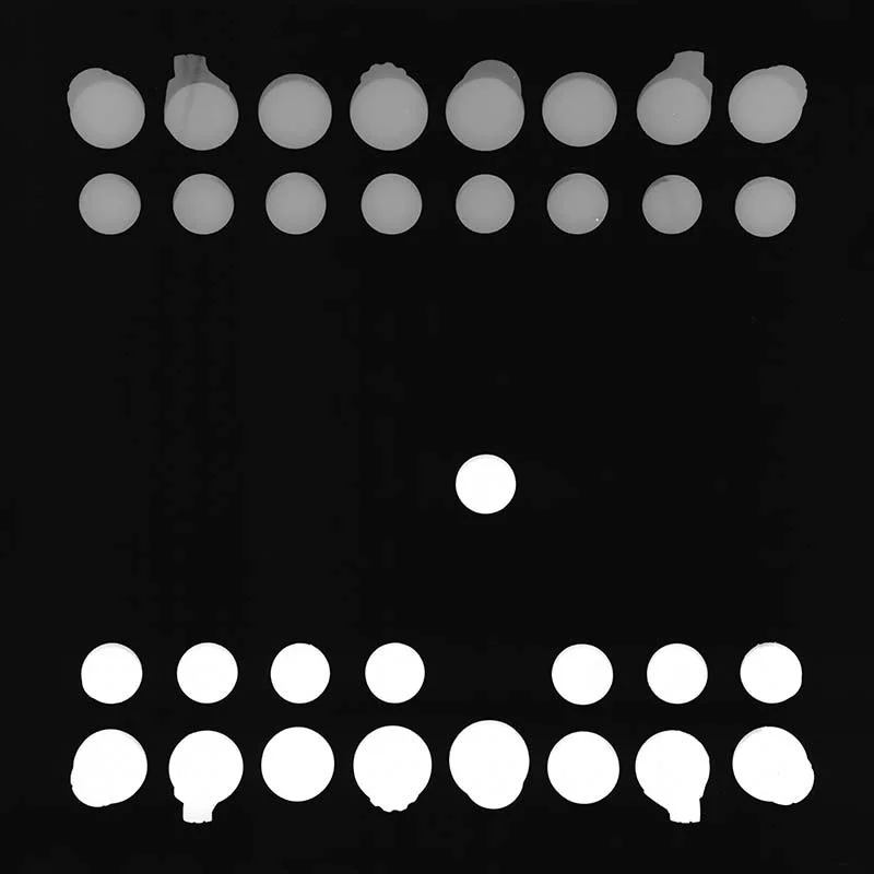 Black background with white dots arranged in a pattern resembling a game of dominoes or a similar tile game, with a single white dot in the center.
