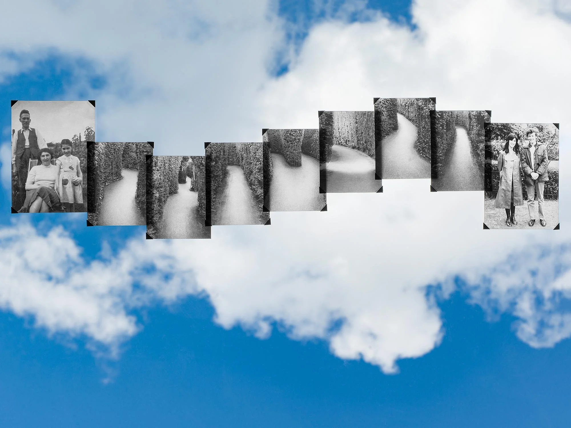 Black and white photo collage of childhood photos and a pathway, floating in the sky among clouds.
