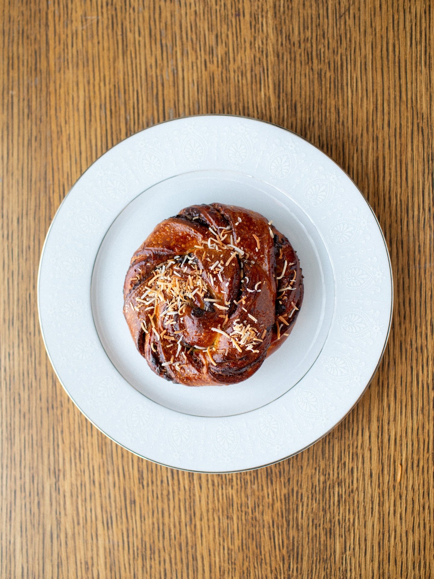 Toasted Coconut &amp; Chocolate Bun.

Available at both locations!