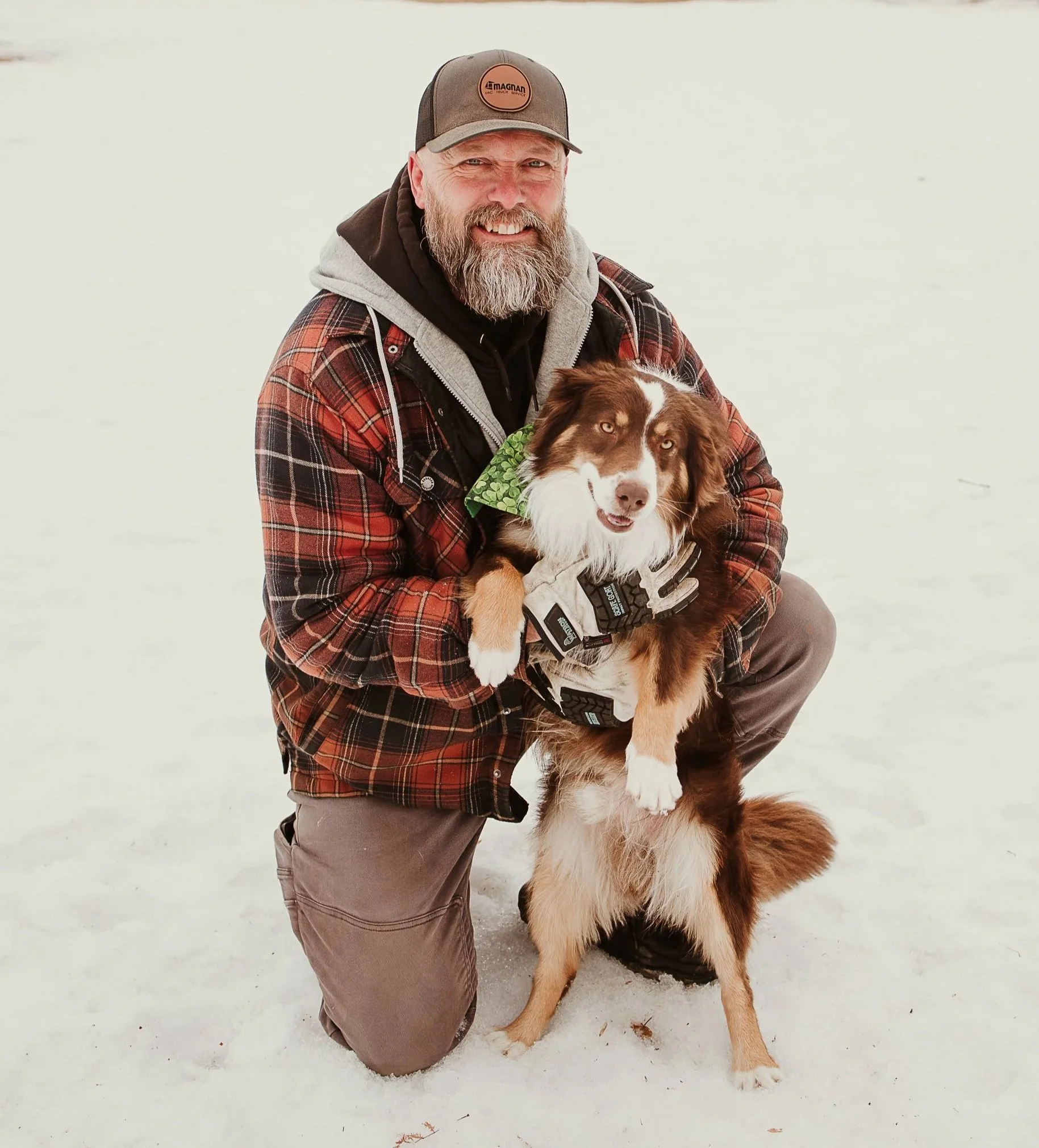 A woman sitting on a bench, writing in a notebook, with abstract artwork leaning against the wall nearby.