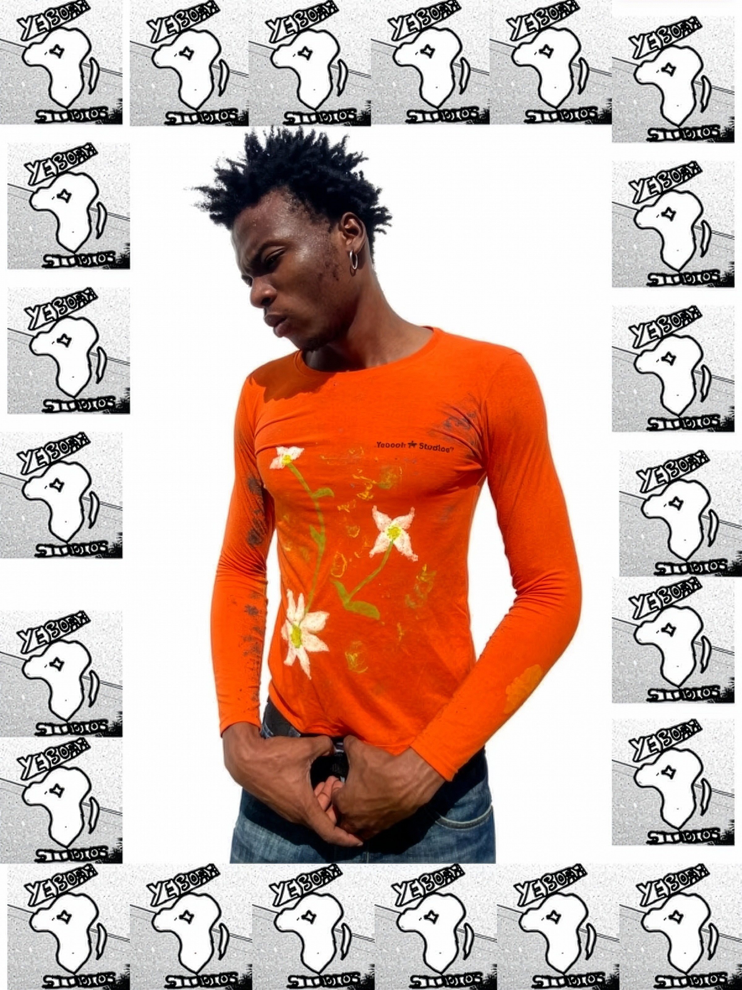 A man with black, spiked hair, wearing a bright orange long-sleeve shirt with floral designs, standing against a white background surrounded by a frame of black-and-white logos that say 'Yeboah Studios' with a stylized map of Africa, and he is holding his hands near his waist.