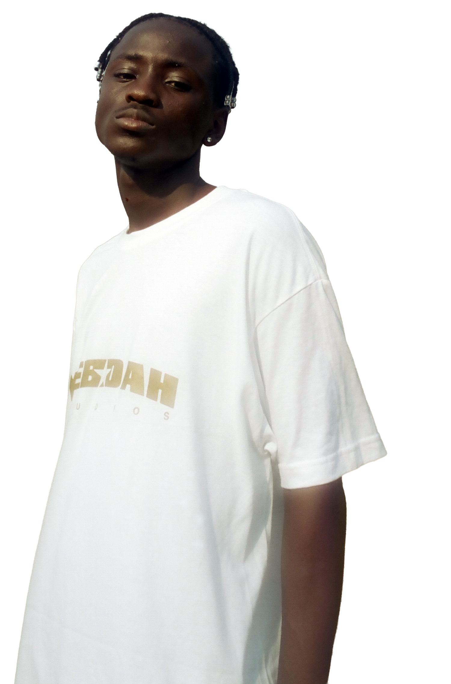 Young person with dark skin and earrings, wearing a white T-shirt with gold text reading YEBOAH Studios, looking at the camera with a neutral expression.