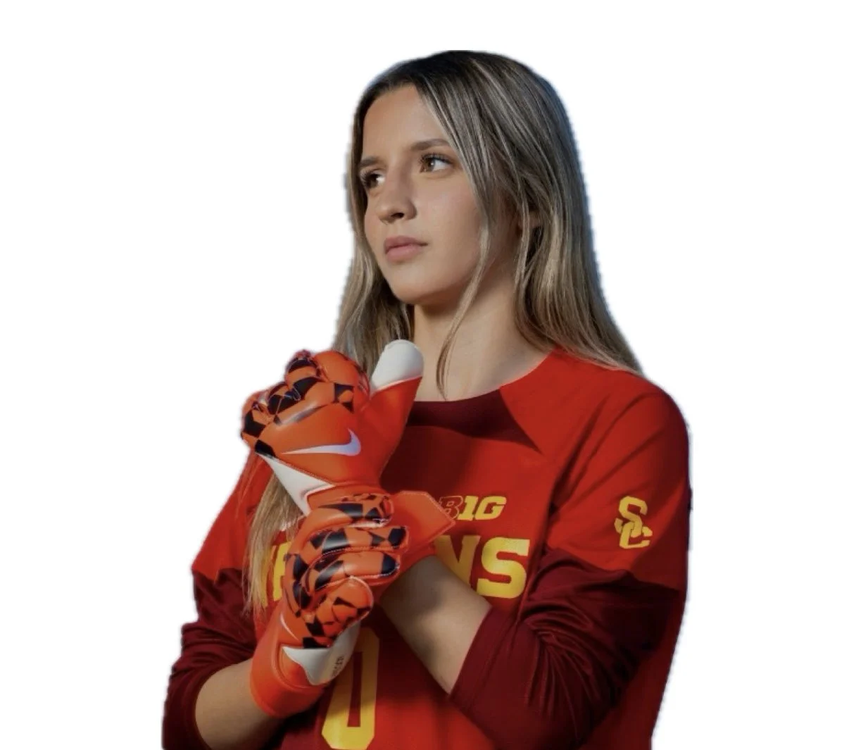 A young woman with long hair wearing a red sports jersey and red goalkeeper gloves, standing against a white background.